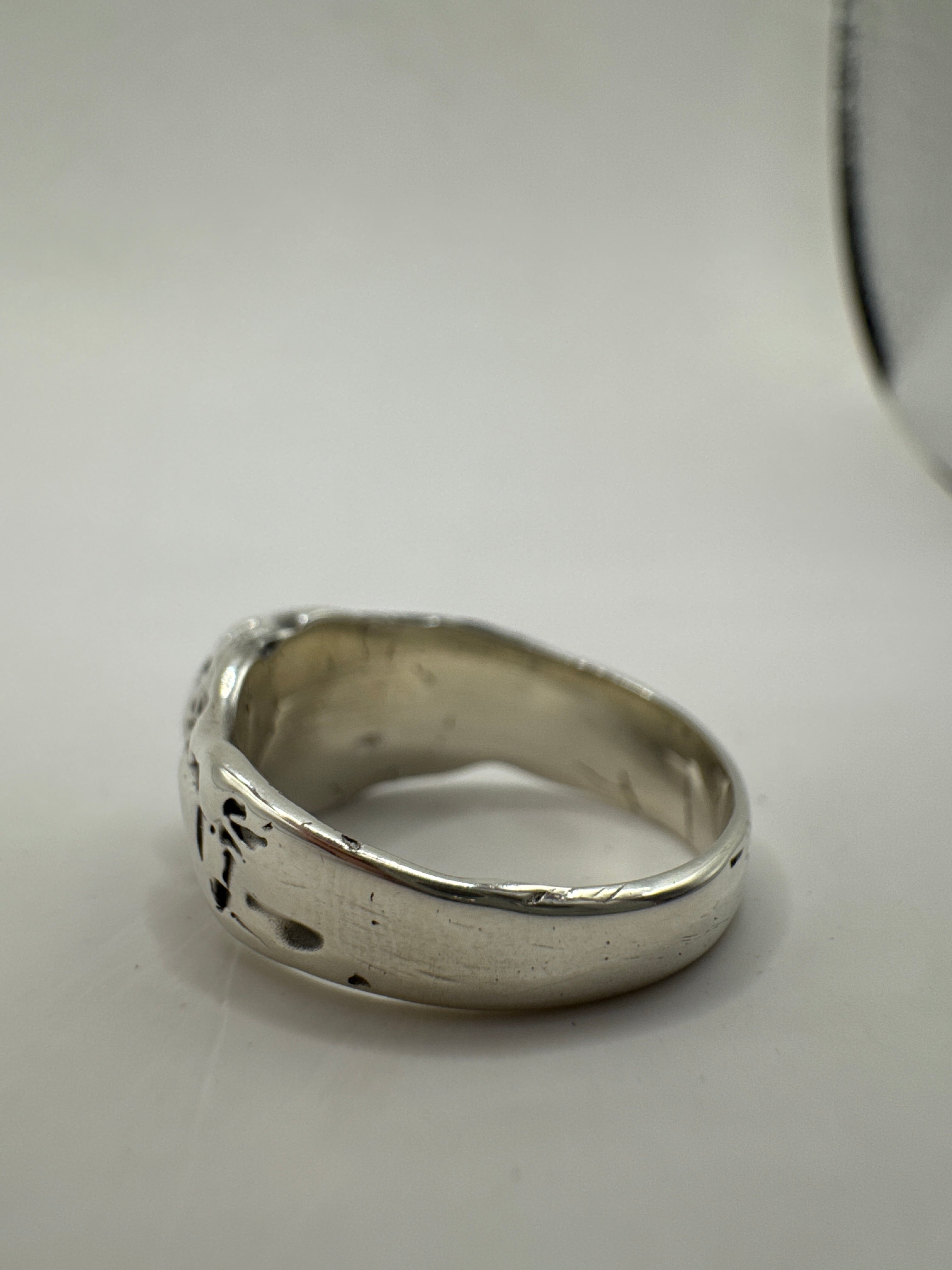 Textured sterling silver ring with natural blue sapphire in bezel setting. Unique gothic design made using lost wax casting technique.