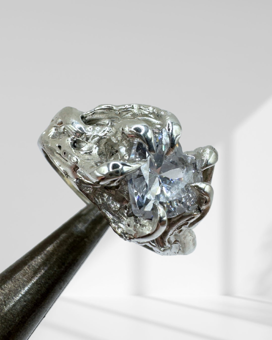 Handmade organic sterling silver gothic ring featuring a heart-shaped clear cubic zirconia, 6 gothic claw prongs, and a molten lost wax texture.