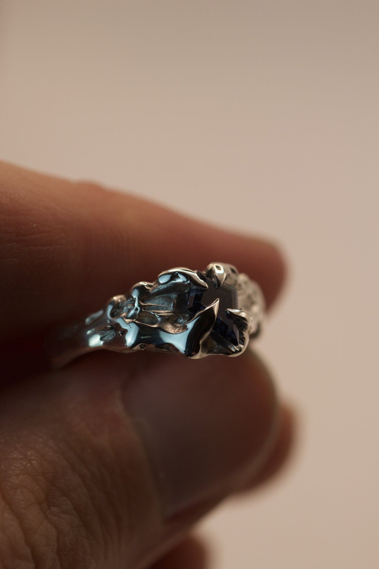 One of a kind ring in sterling silver with heavy molten texture, handmade using the lost wax method. Gothic claws secure a vivid blue kite cut moissanite, perfect for alternative fashion or engagement.