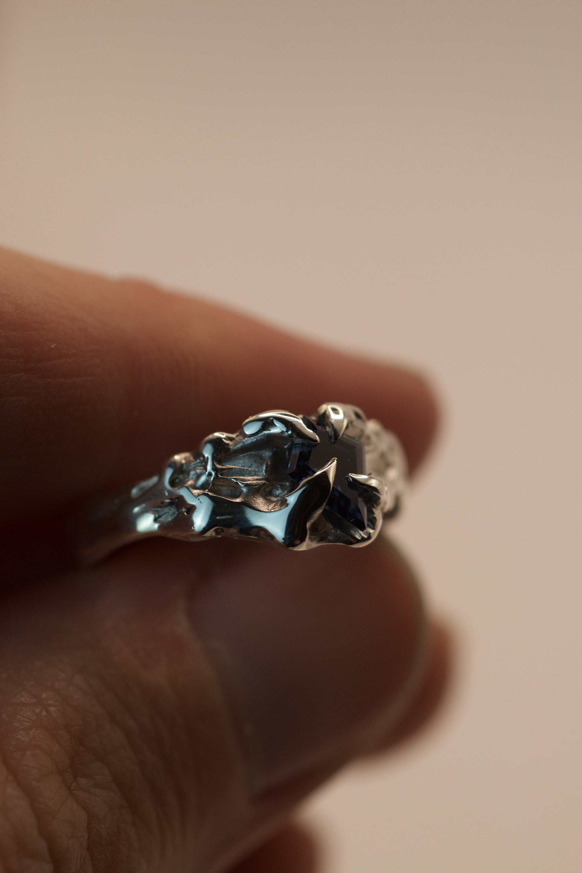 One of a kind ring in sterling silver with heavy molten texture, handmade using the lost wax method. Gothic claws secure a vivid blue kite cut moissanite, perfect for alternative fashion or engagement.