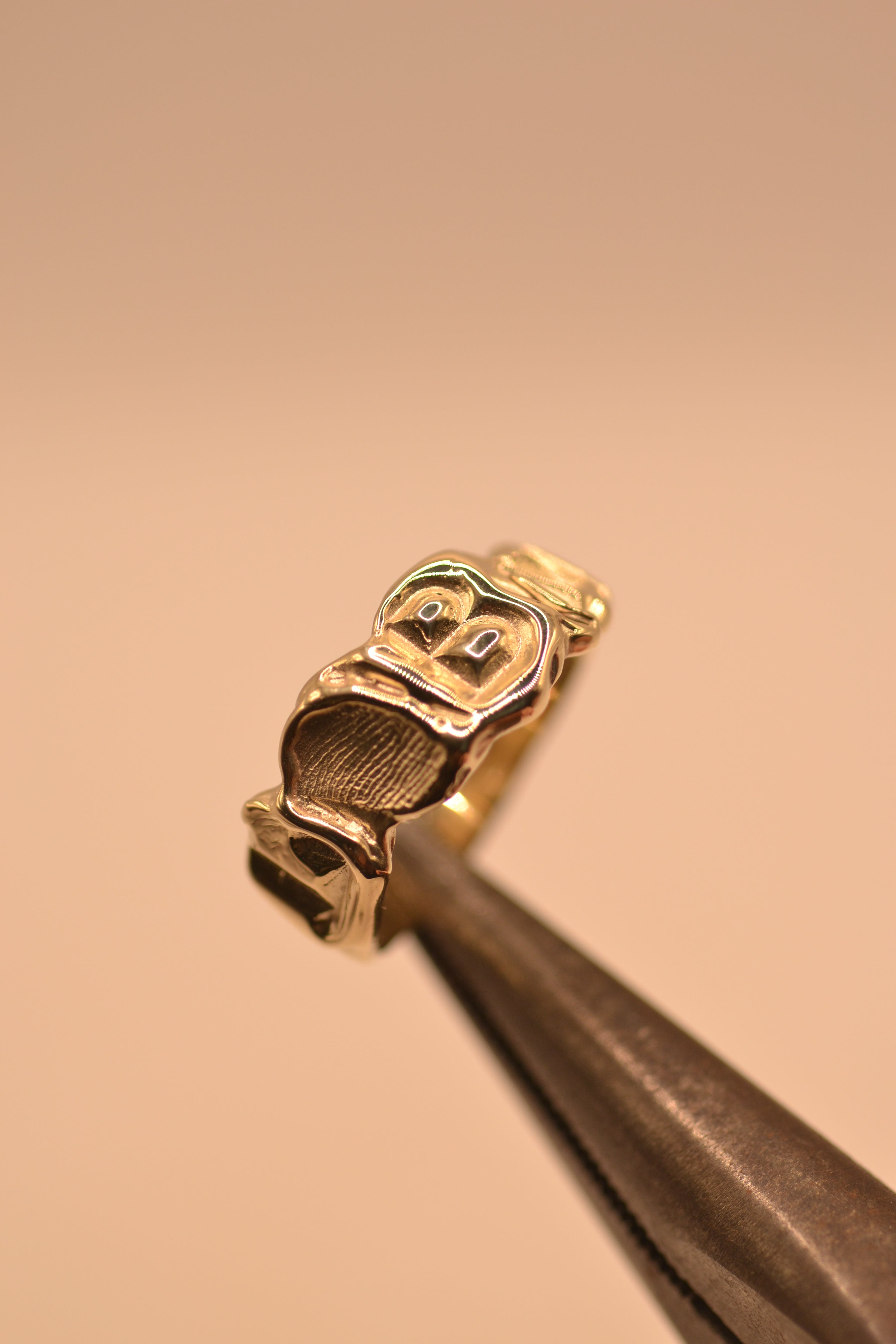 Lost wax cast personalised gold ring displayed showing initial lettering and band width