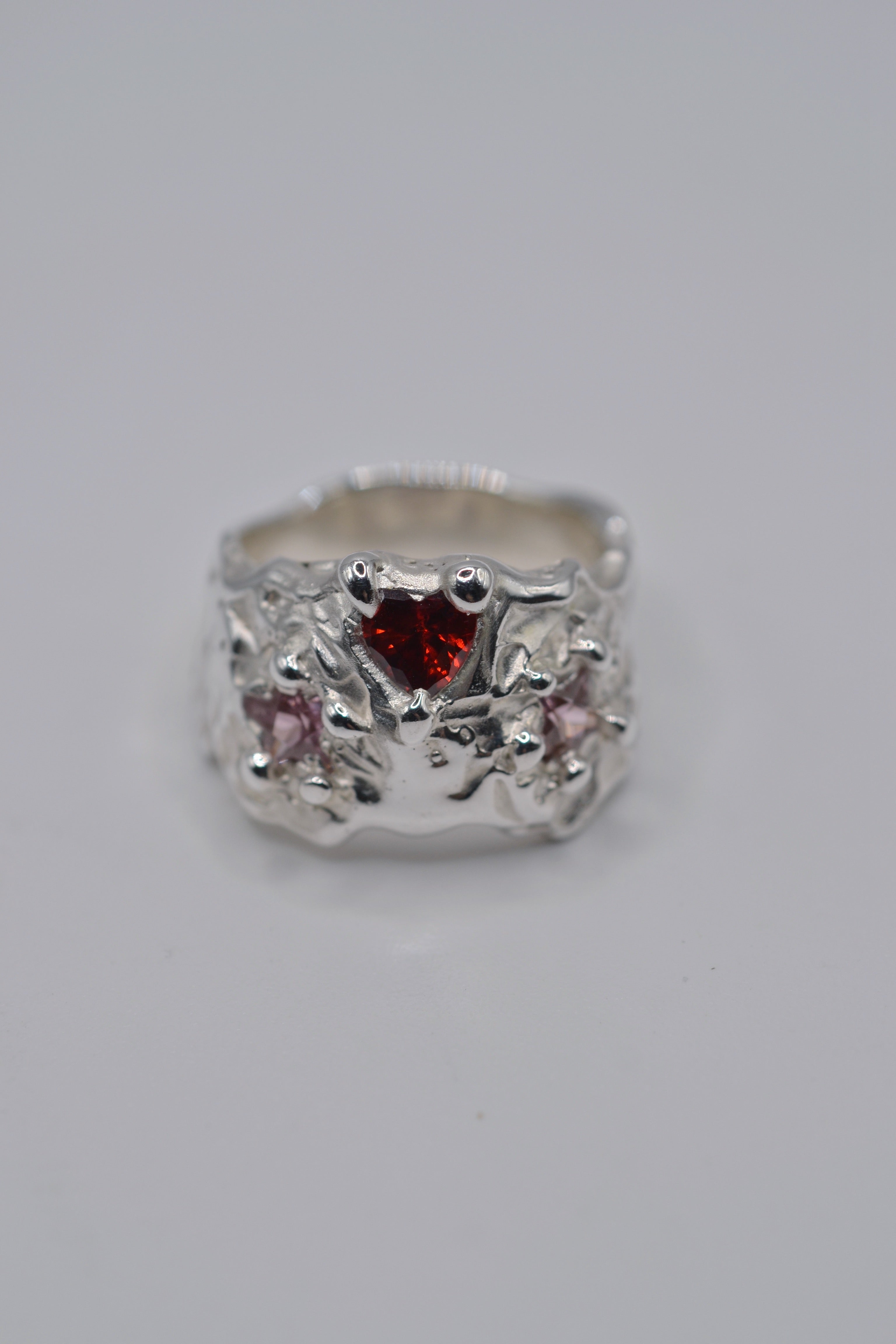 Red stone alternative engagement ring. Handmade sterling silver, lost wax casting, molten sculptural band. Metal Bones Jewellery.
