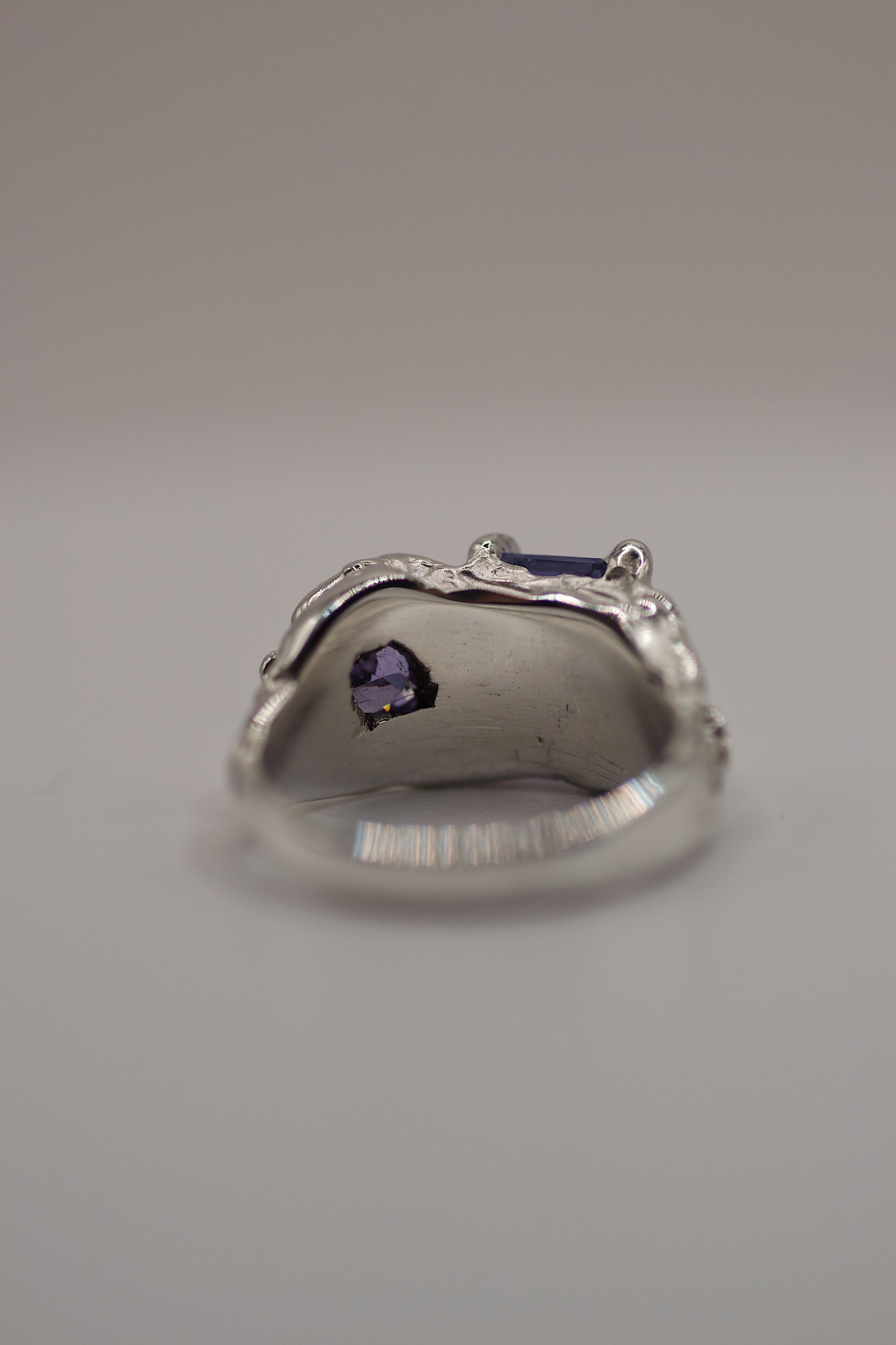 Angled underside of the ring, showing the smooth but slightly rugged inner band and the gothic exterior detail from the lost wax process.

