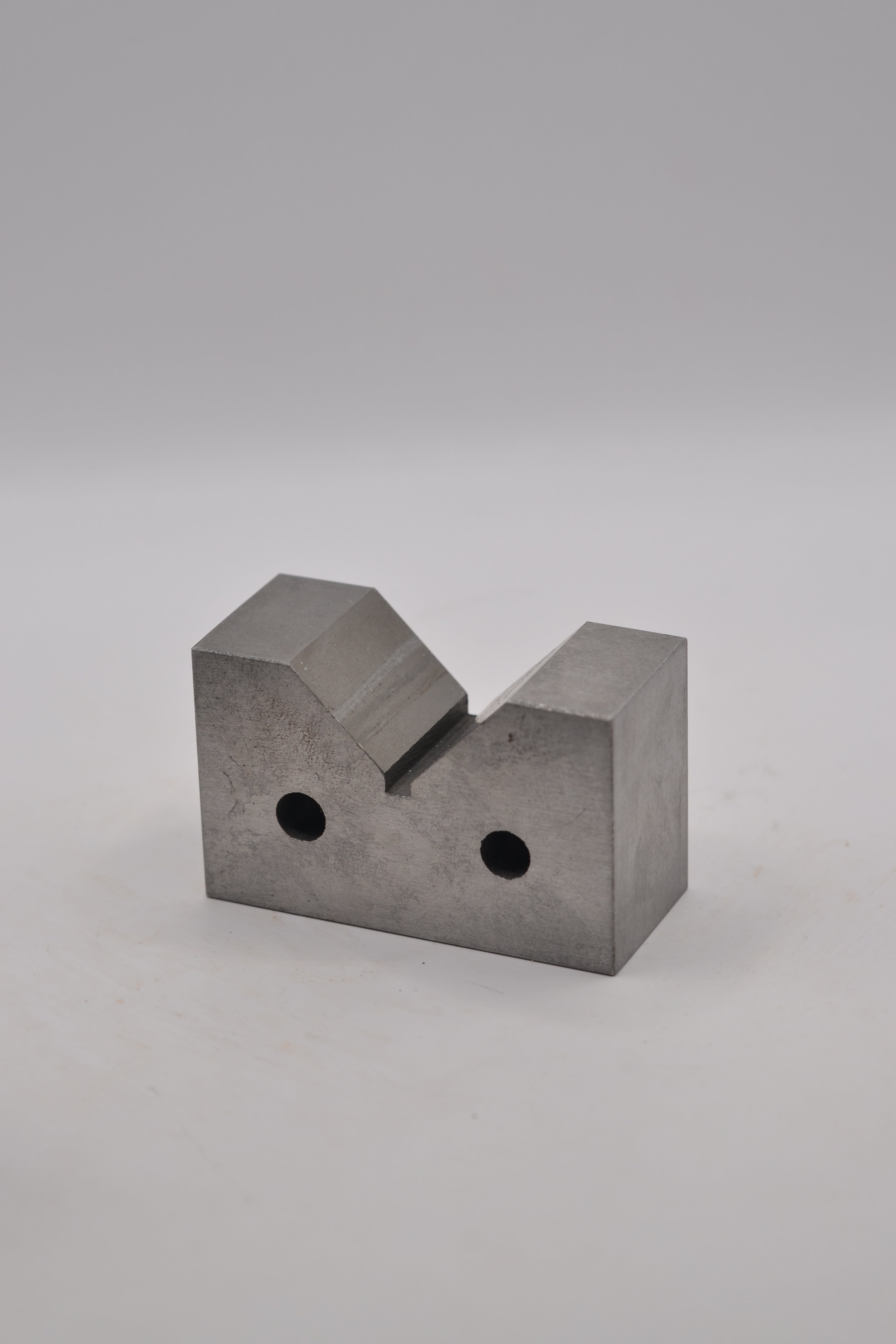 Angled side view of cast iron ring mandrel holder showing the V-shaped cradle.