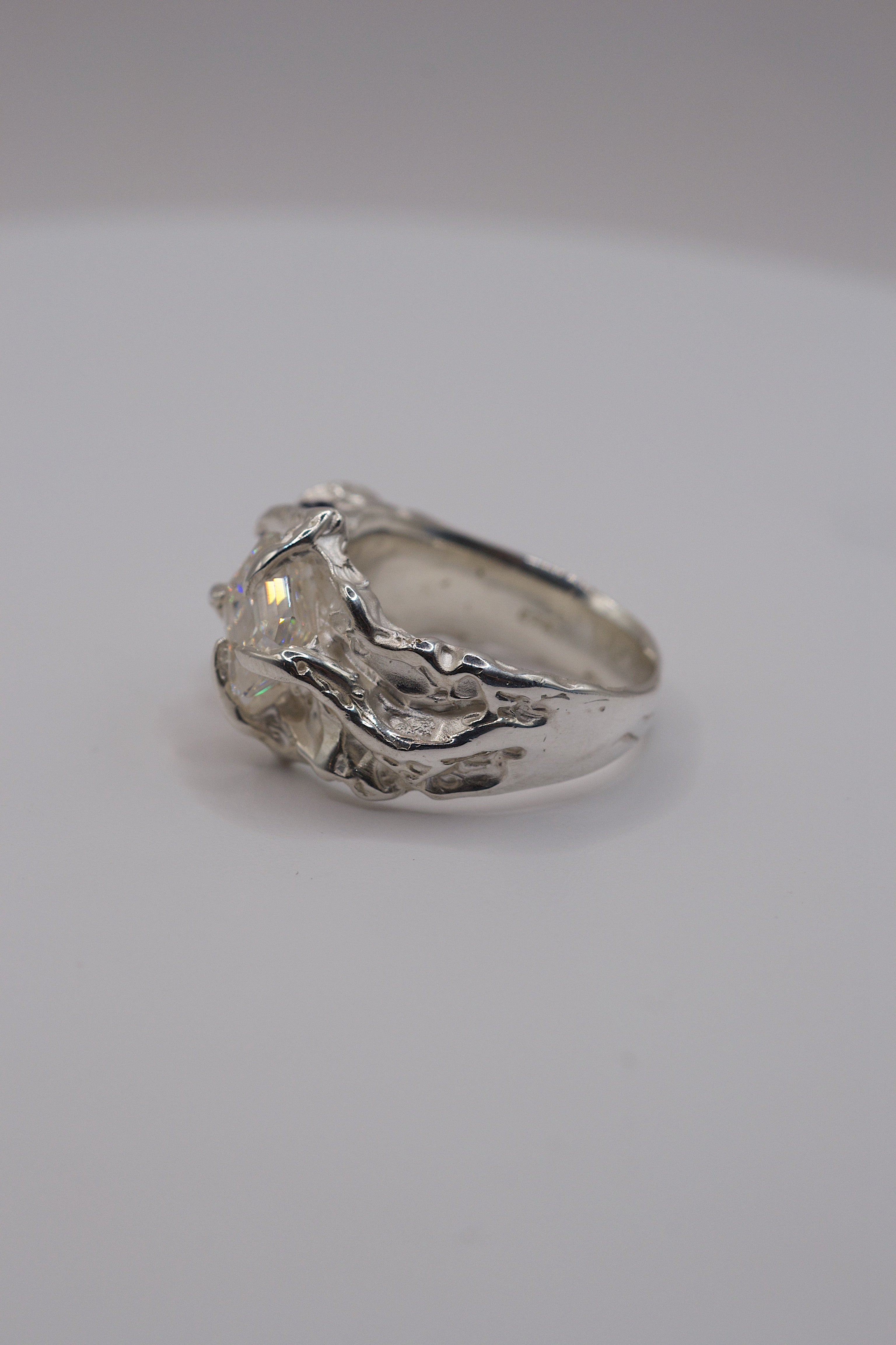 Side view of heavily textured sterling silver ring with details created with a soldering iron.