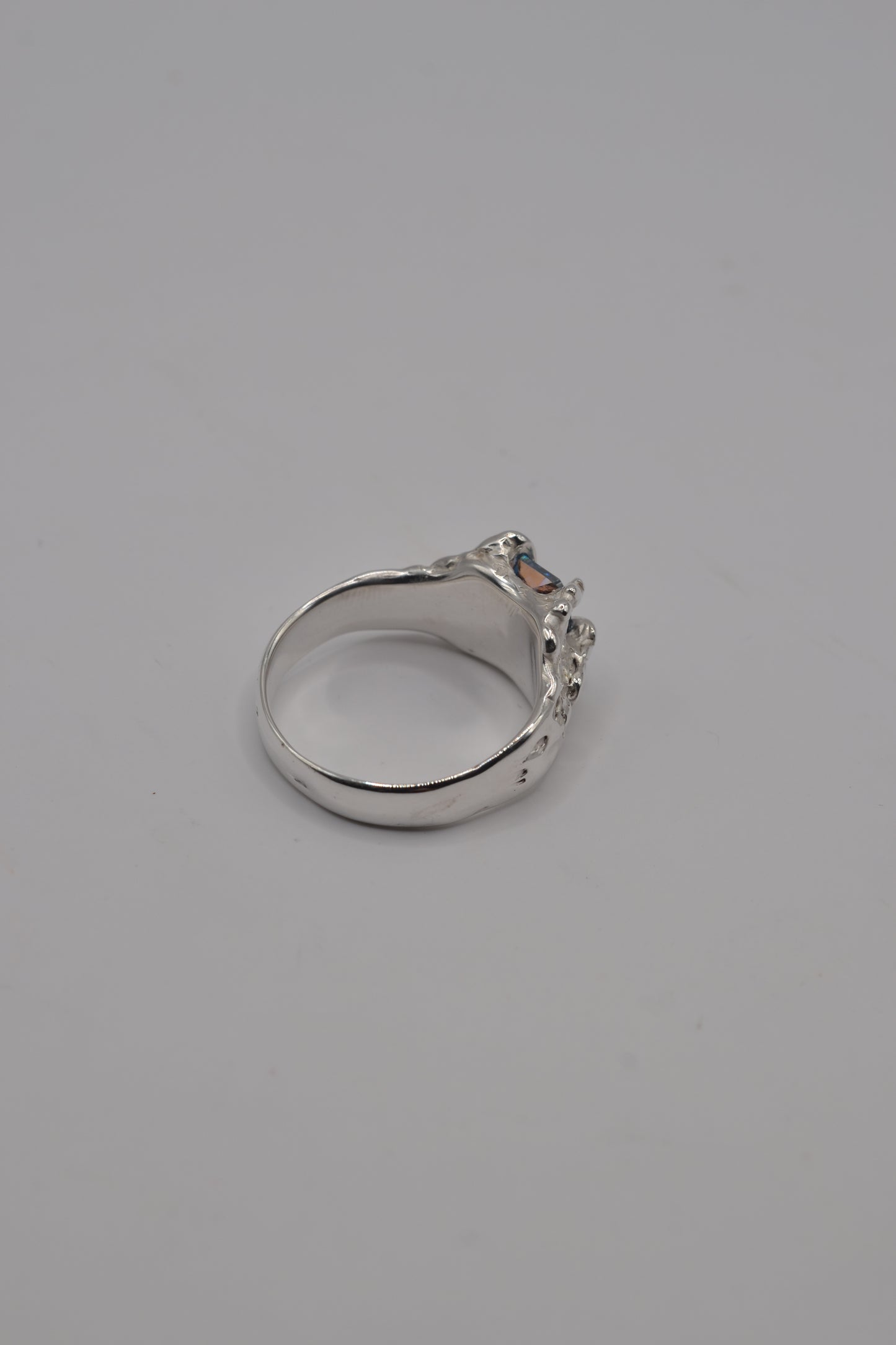 Handcrafted sterling silver ring made with lost wax casting, showing the smooth inner band and sculptural exterior.