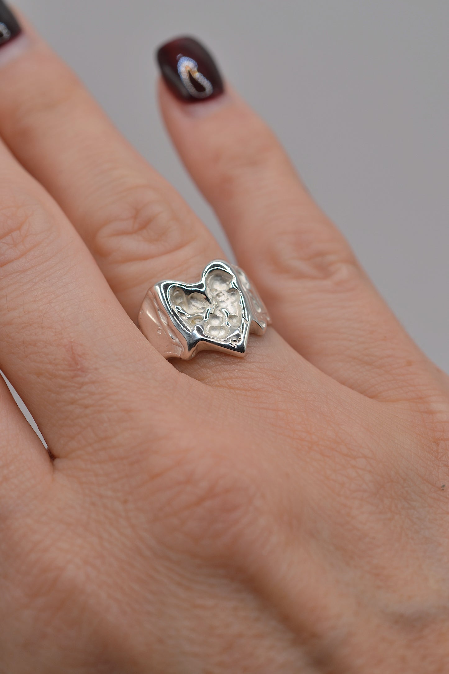 Organic lost wax cast ring worn on hand, sterling silver heart ring with molten organic finish