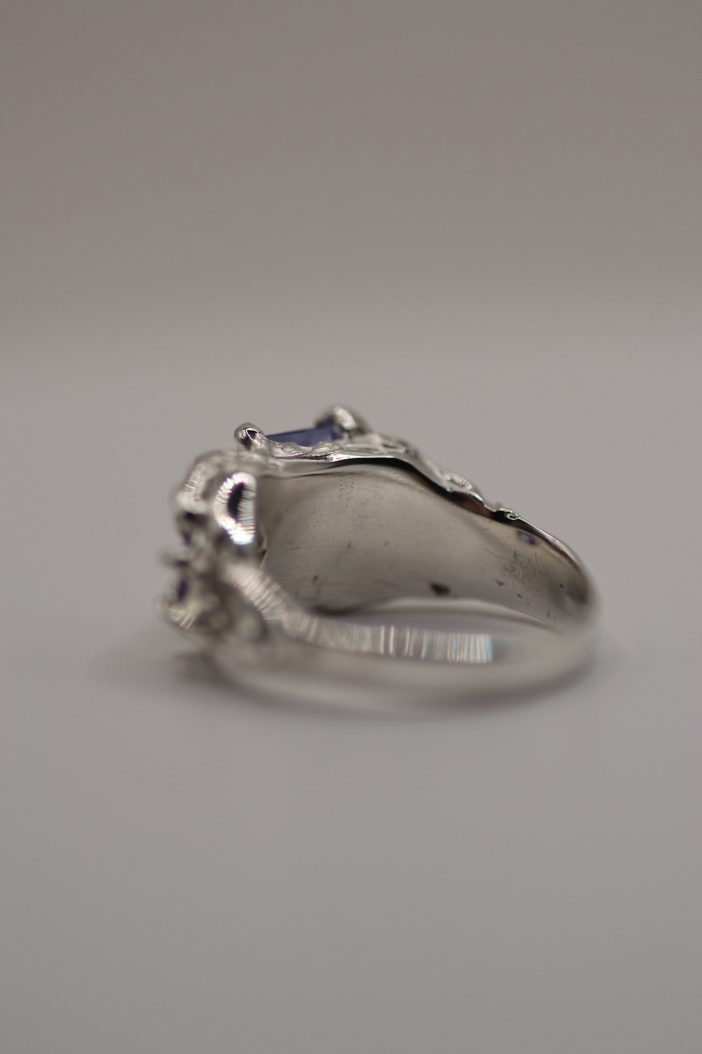 Angled underside of the ring, showing the smooth but slightly rugged inner band and the gothic exterior detail from the lost wax process.