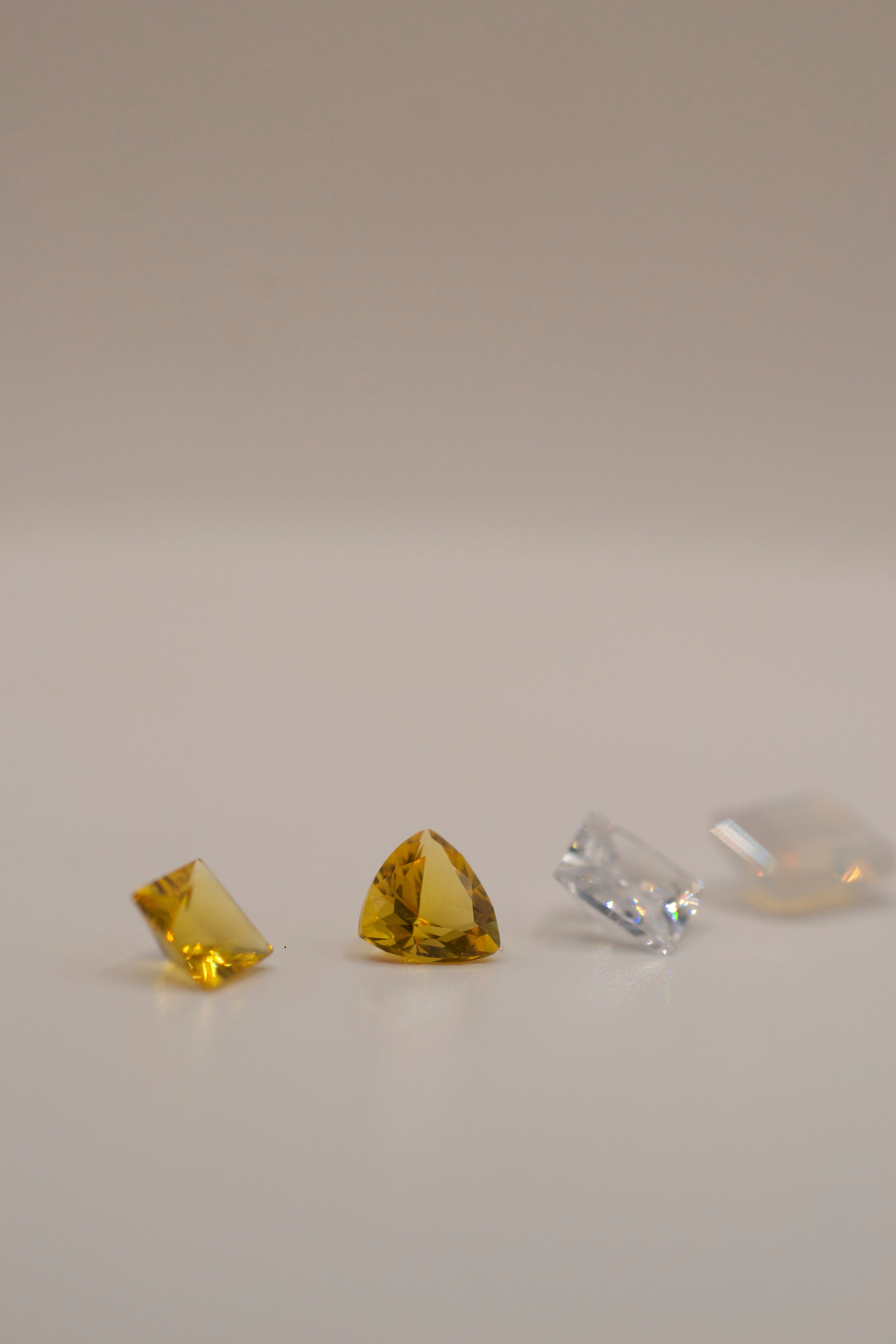 Faceted gemstones for wax carving and jewelry casting in place. Includes yellow, clear, and opalescent stones in a variety of cuts.