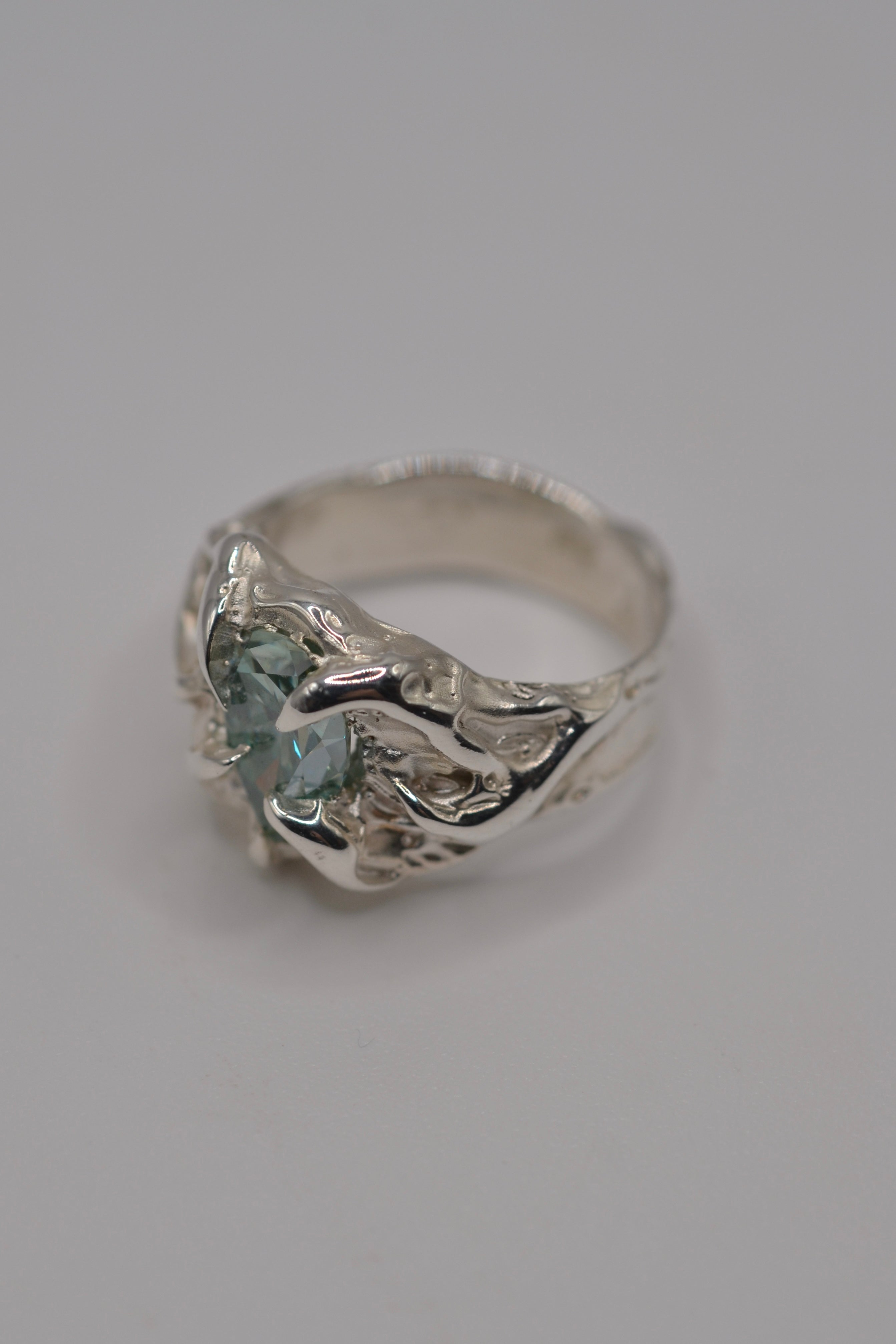 Detail shot of the Wrangler ring. Handmade organic silver, sculpted using wax carving and lost wax casting. Alternative engagement ring with aqua stone. Metal Bones Jewellery.