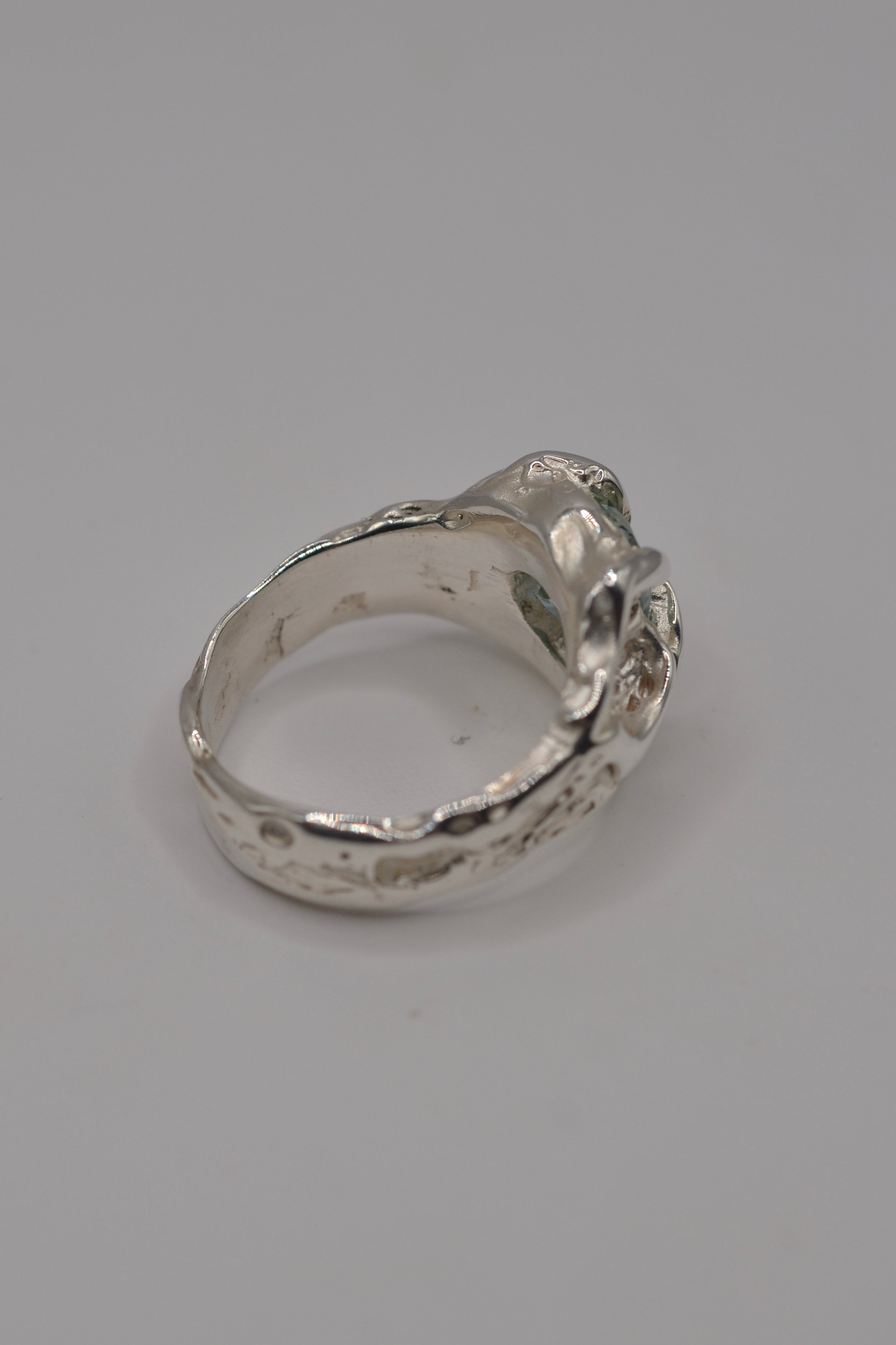 Side profile of the Wrangler ring. Handmade organic silver, wax carved and lost wax cast. Alternative engagement ring with blue stone. Metal Bones Jewellery.