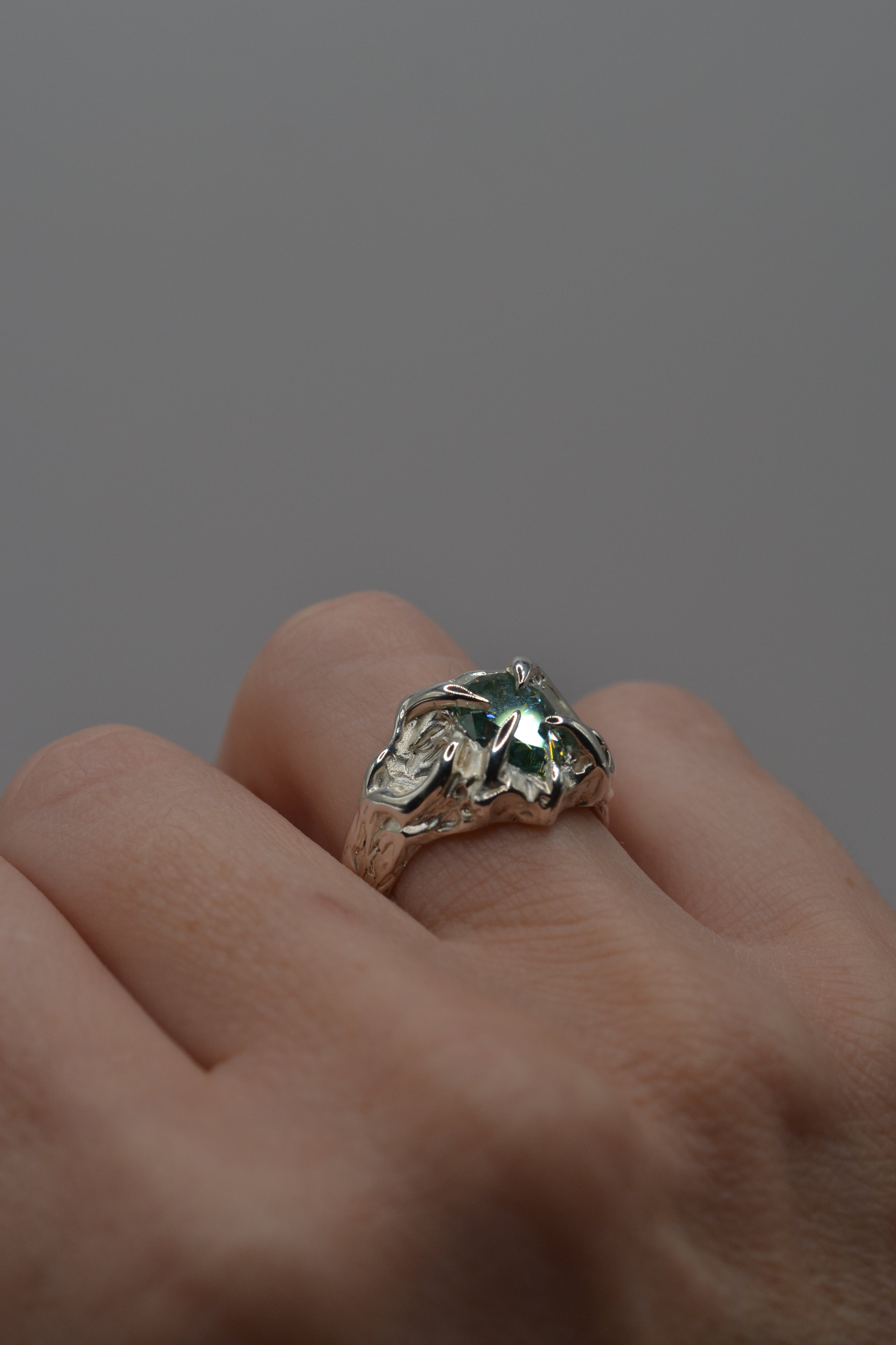 The Wrangler ring worn. Handmade organic silver, wax carved and lost wax cast. Unique alternative engagement ring with blue stone. Metal Bones Jewellery.