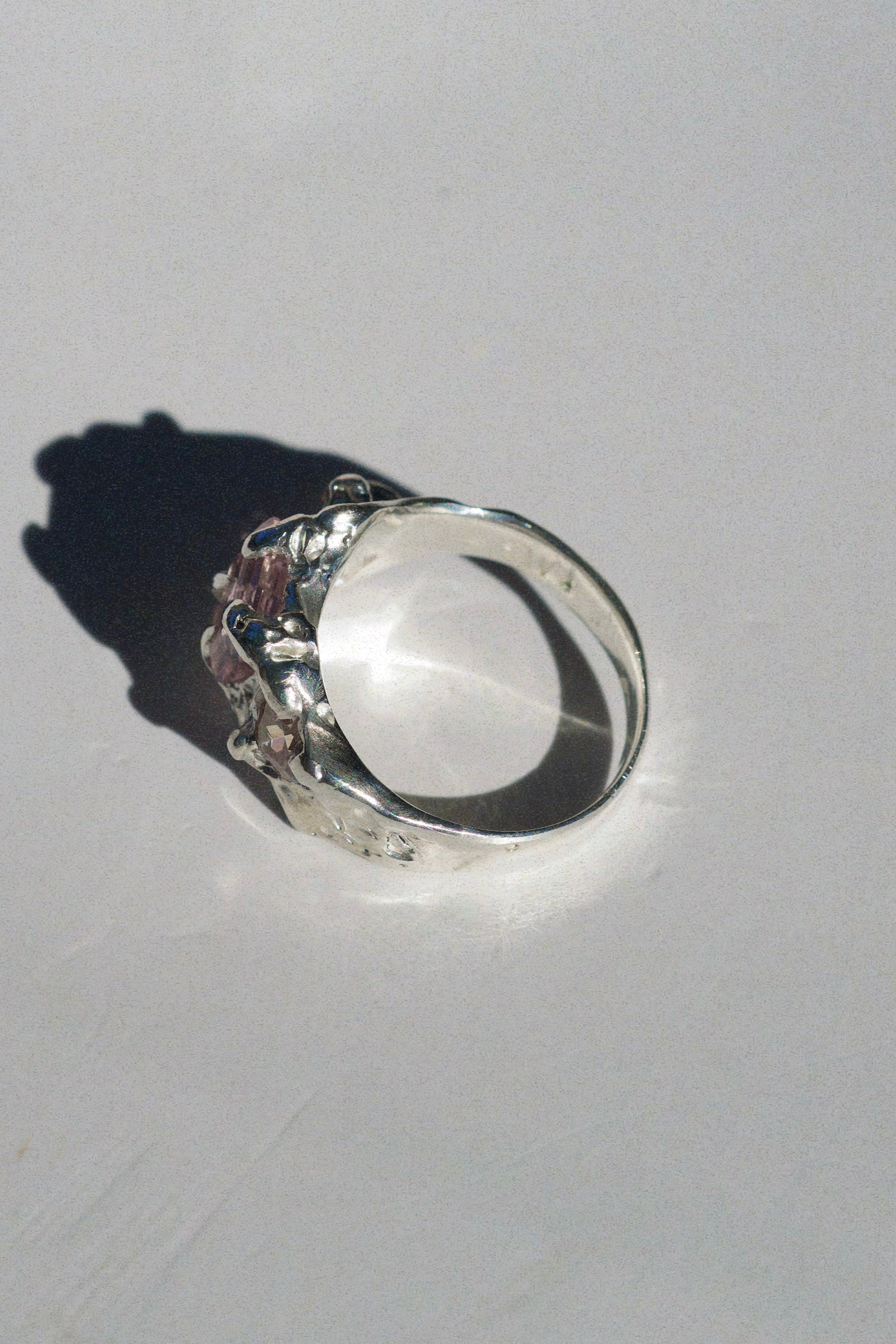 Sculptural non traditional engagement ring lost wax cast in sterling silver with pink tourmaline and heart shaped cubic zirconia