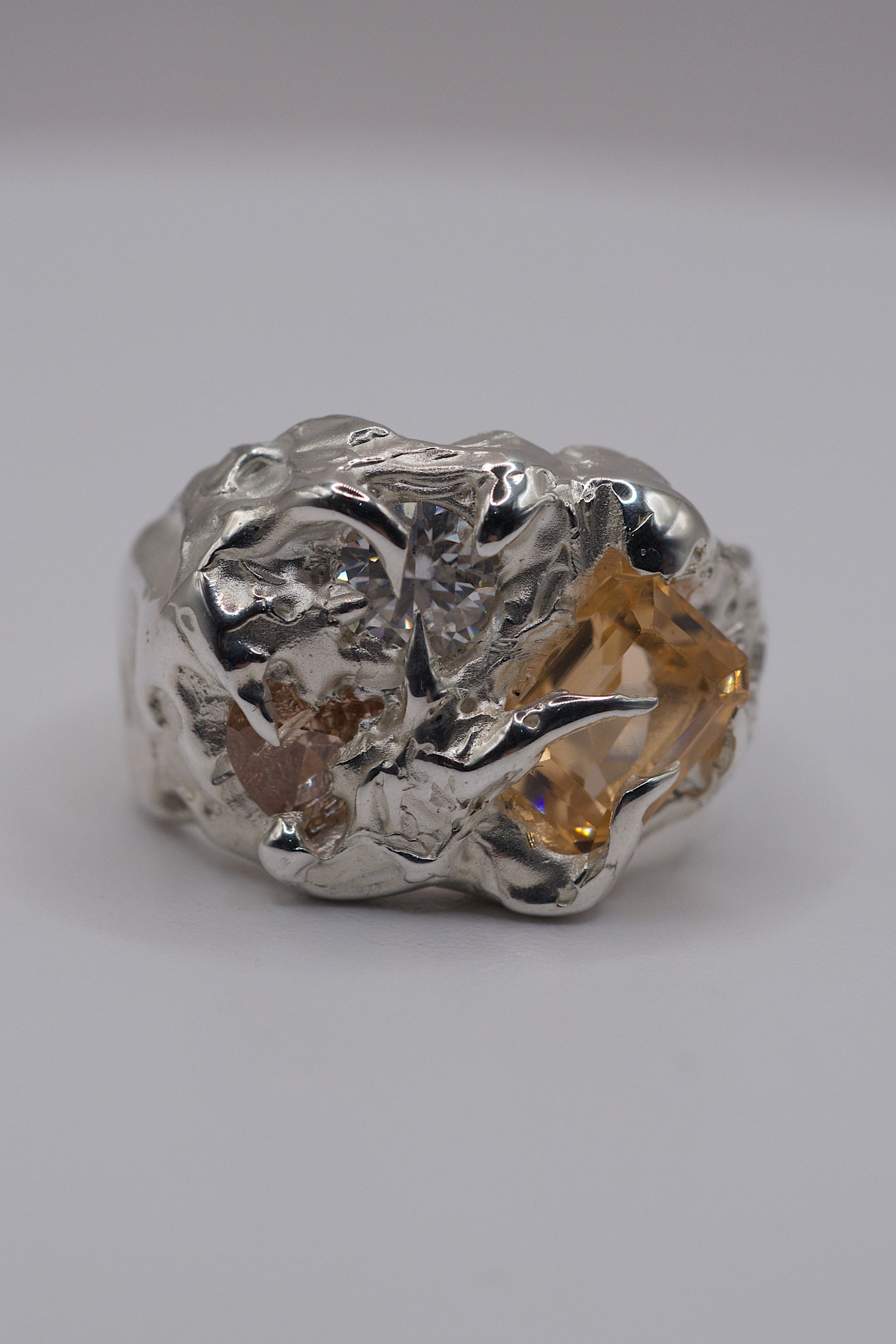Close up of the Butterscotch Ring showing champagne nanocrystal and white moissanite set within organic molten sterling silver claws handmade using the lost wax technique