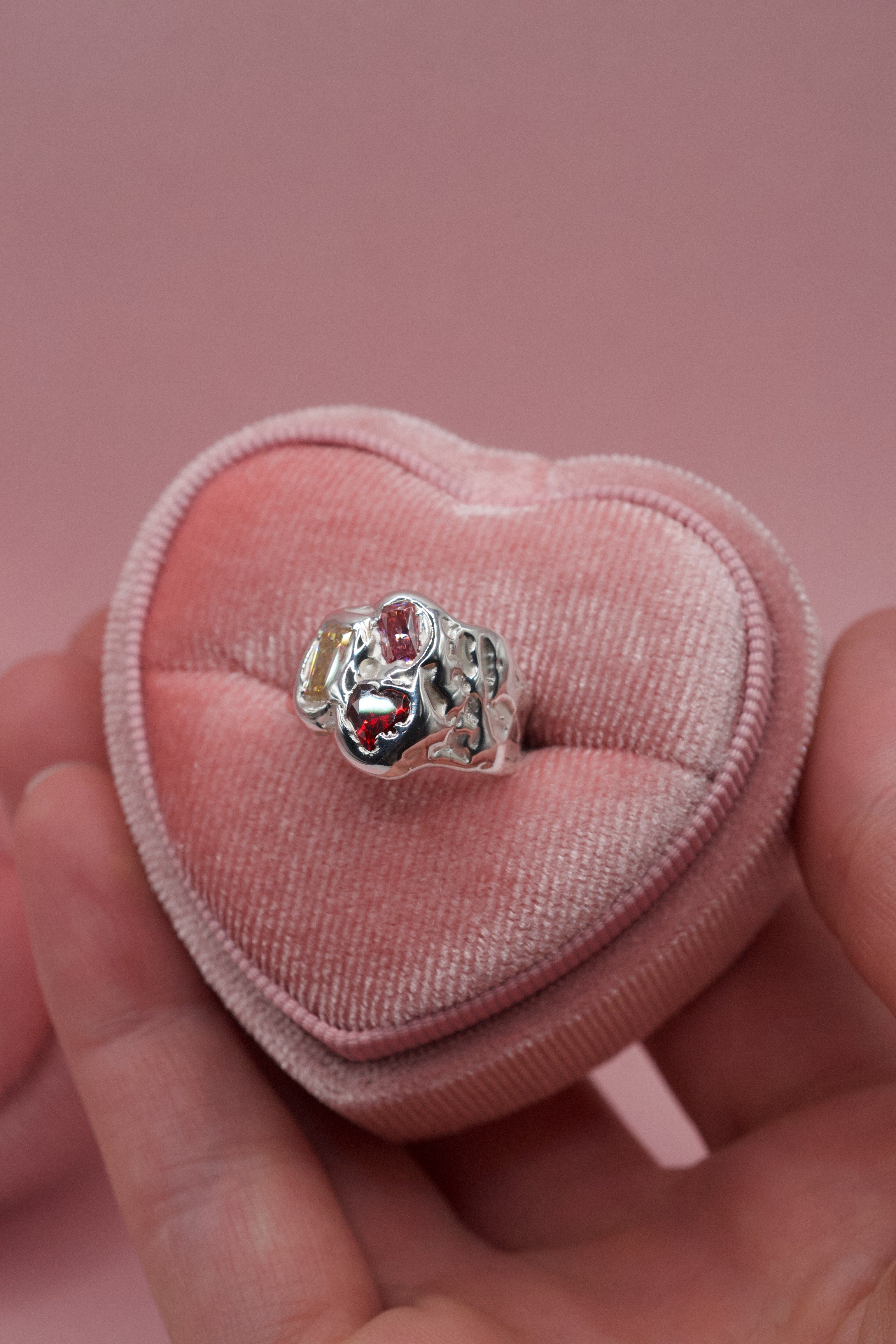Colourful sculptural sterling silver Candy Ring with candy-shaped gemstones on pink surface handmade using the lost wax technique alternative jewellery