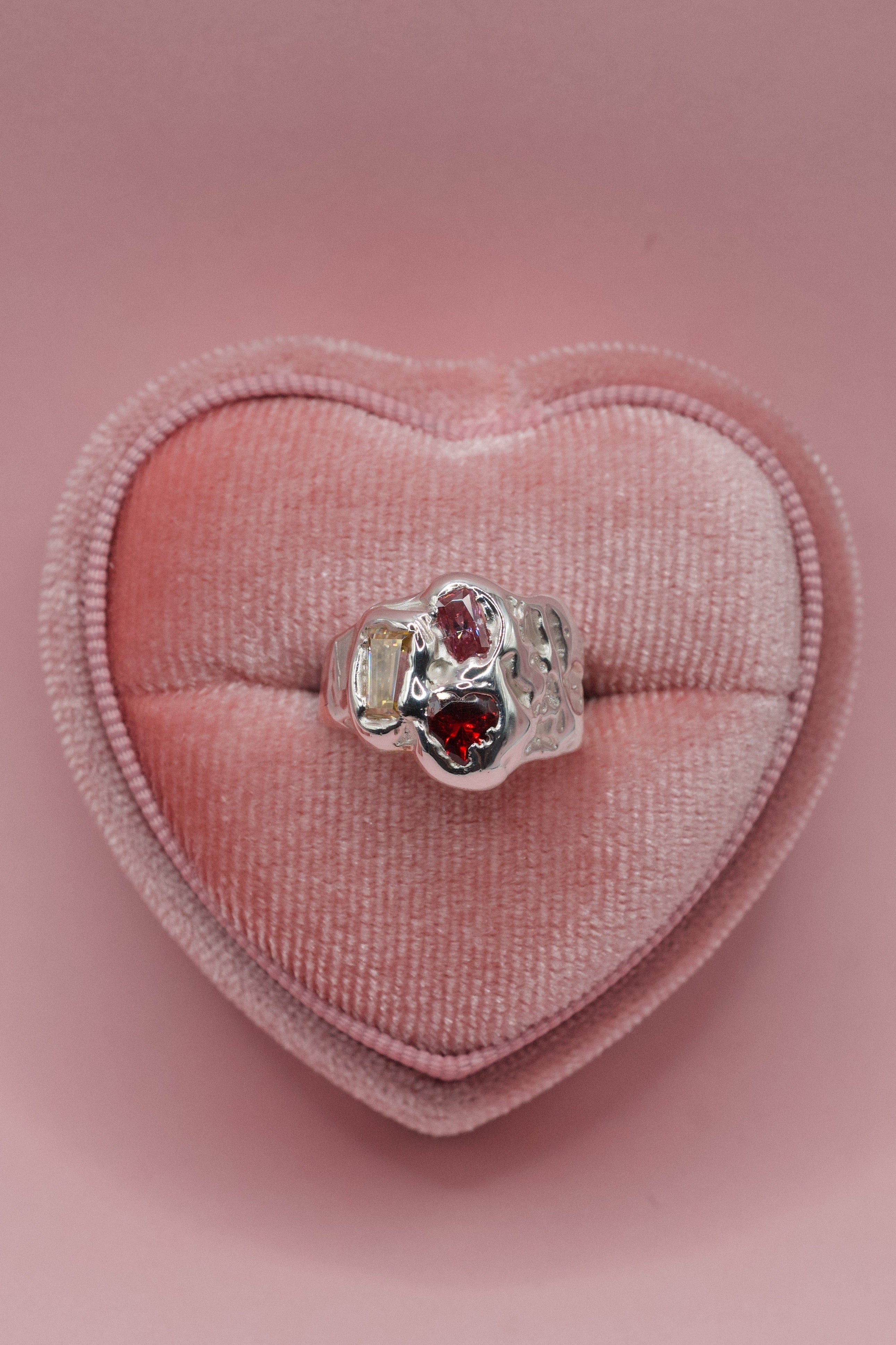 Lost wax cast silver Candy Ring in heart shaped ring box with yellow moissanite and red cubic zirconia stones handmade using the wax carving technique