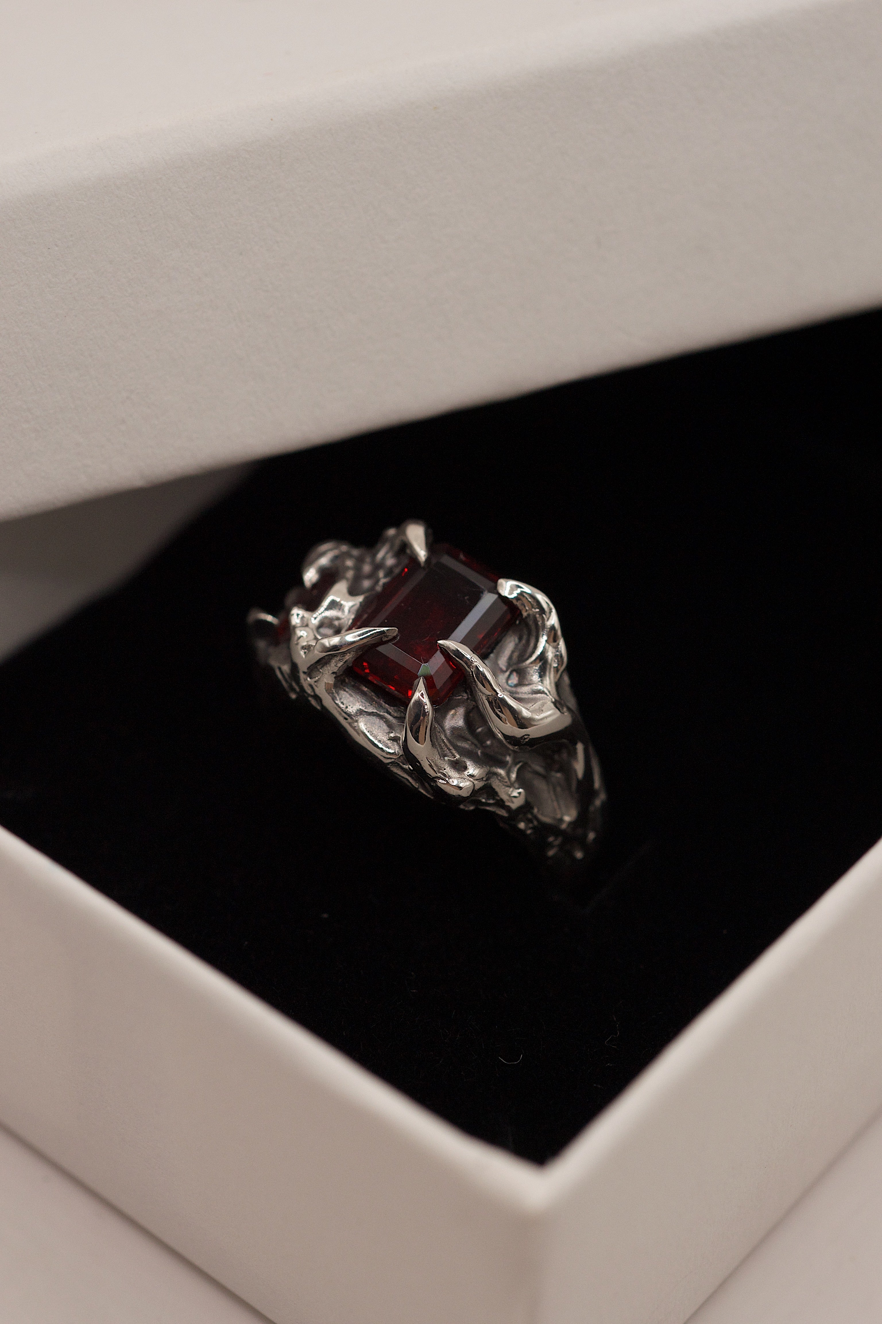 Lost wax cast silver Cherry Ring with red garnet and sharp organic claw setting in black ring box handmade alternative jewellery