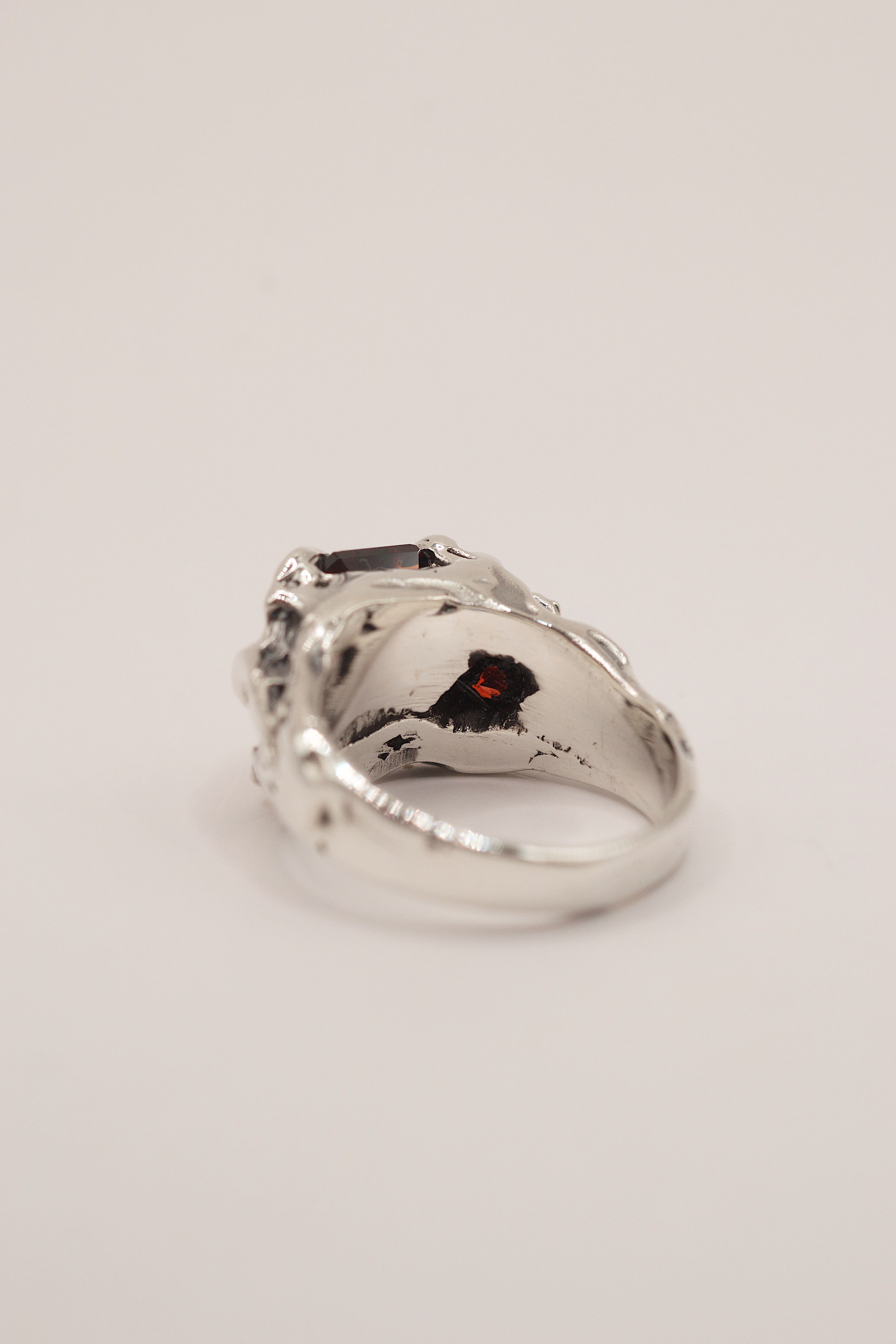 Front view of the Cherry Ring showing red lab-grown garnet and heart cubic zirconia within sharp organic sterling silver claws lost wax cast