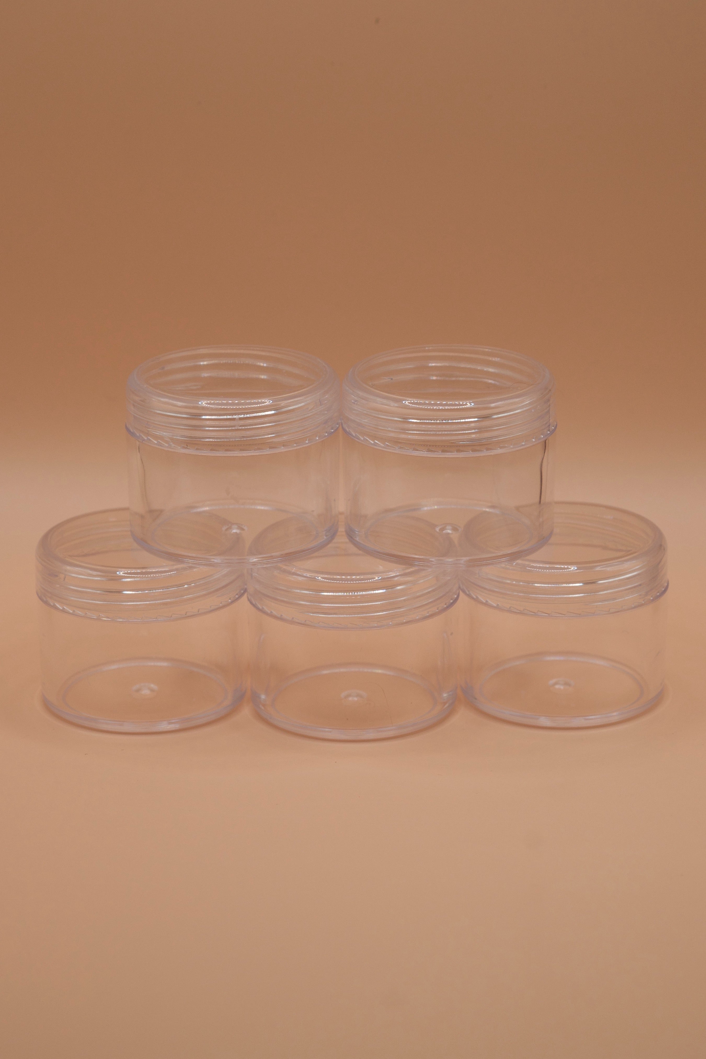 Set of five clear plastic jars for safely sending wax jewellery models to a casting house.