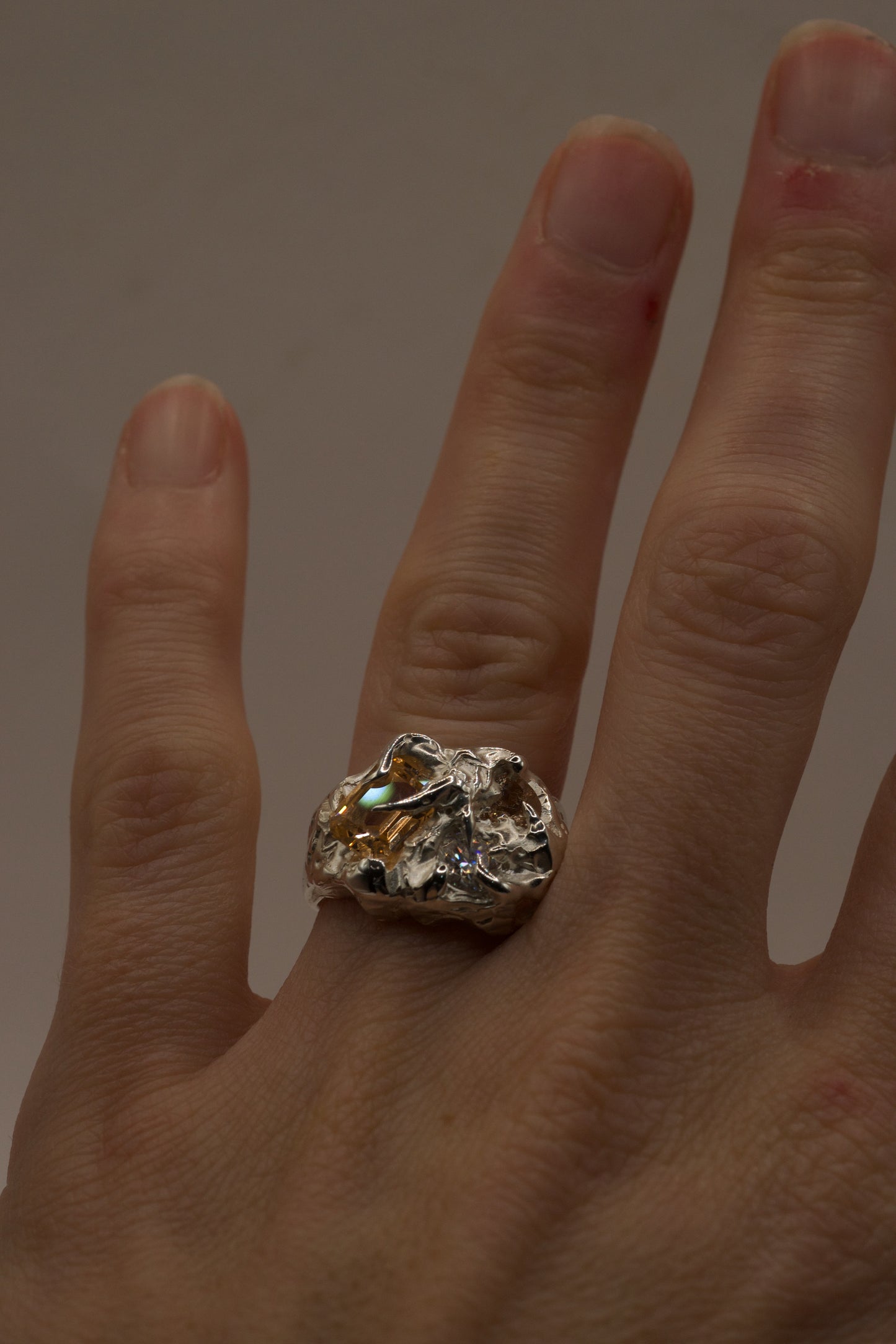 Beautiful molten silver ring with citrine gemstones on hand.