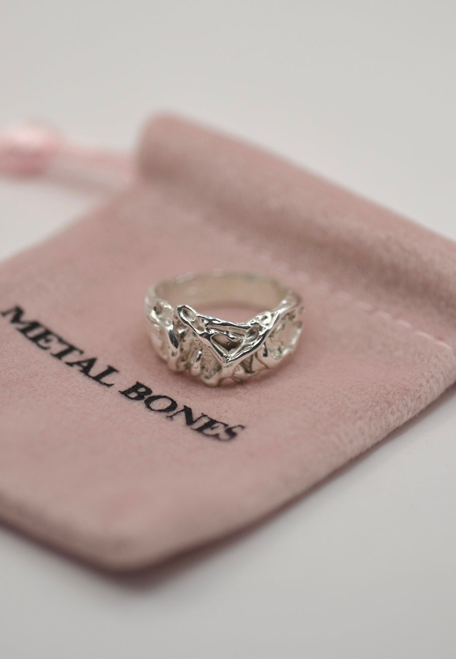 Lost wax cast silver Cream Ring with layered organic molten texture wrapped in pink tissue paper handmade alternative jewellery