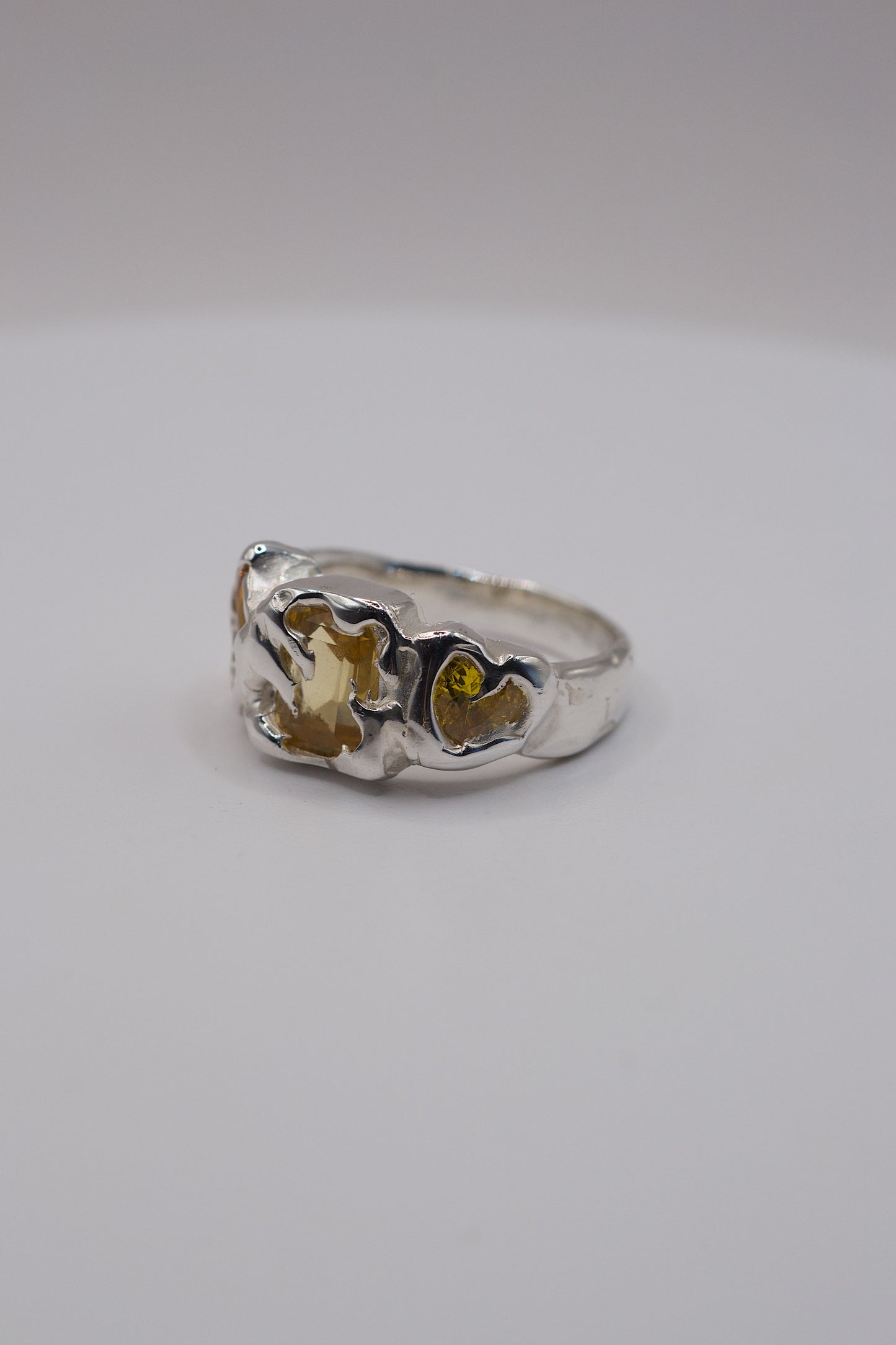 Alternative silver ring with heart-shaped gemstone on a white background