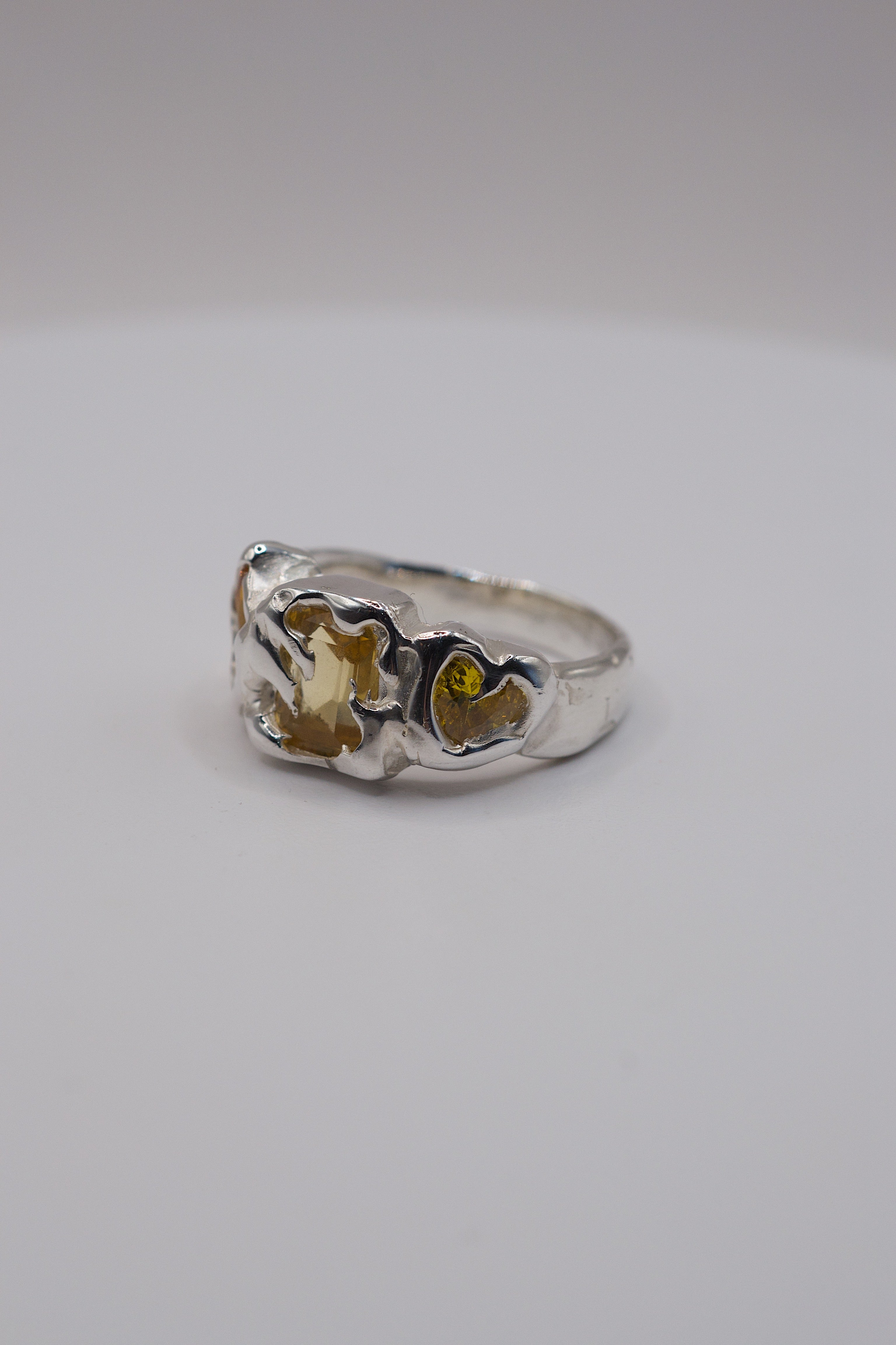 Side angle of the Crystallised Honey Ring showing organic recycled sterling silver band and golden citrine setting handmade using lost wax casting