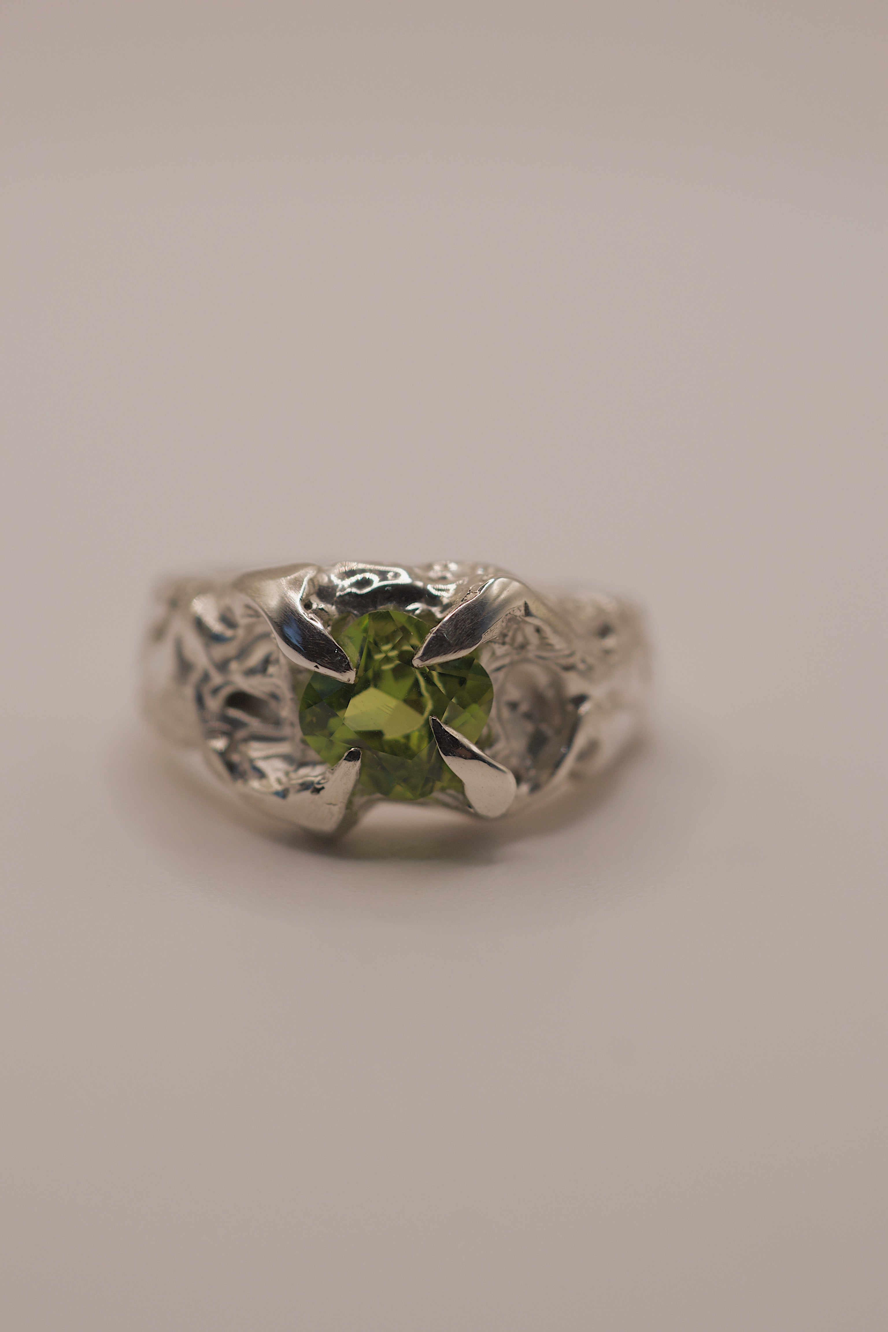 Front view of the Fern Ring showing cushion cut lab-grown peridot set within organic textured molten sterling silver handmade using lost wax casting
