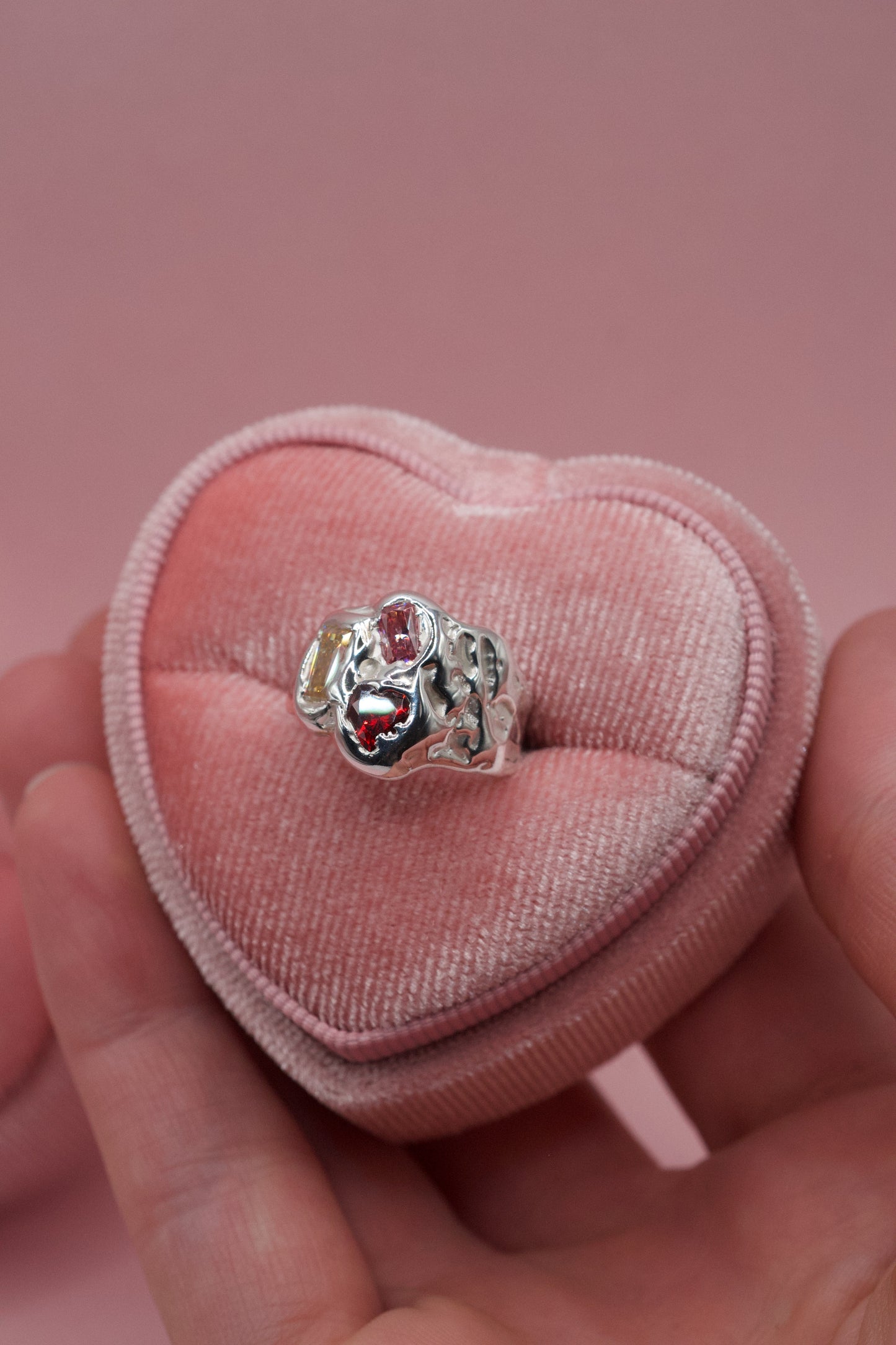 Handmade sterling silver ring with molten textures and multiple gemstones in a cluster organic design.