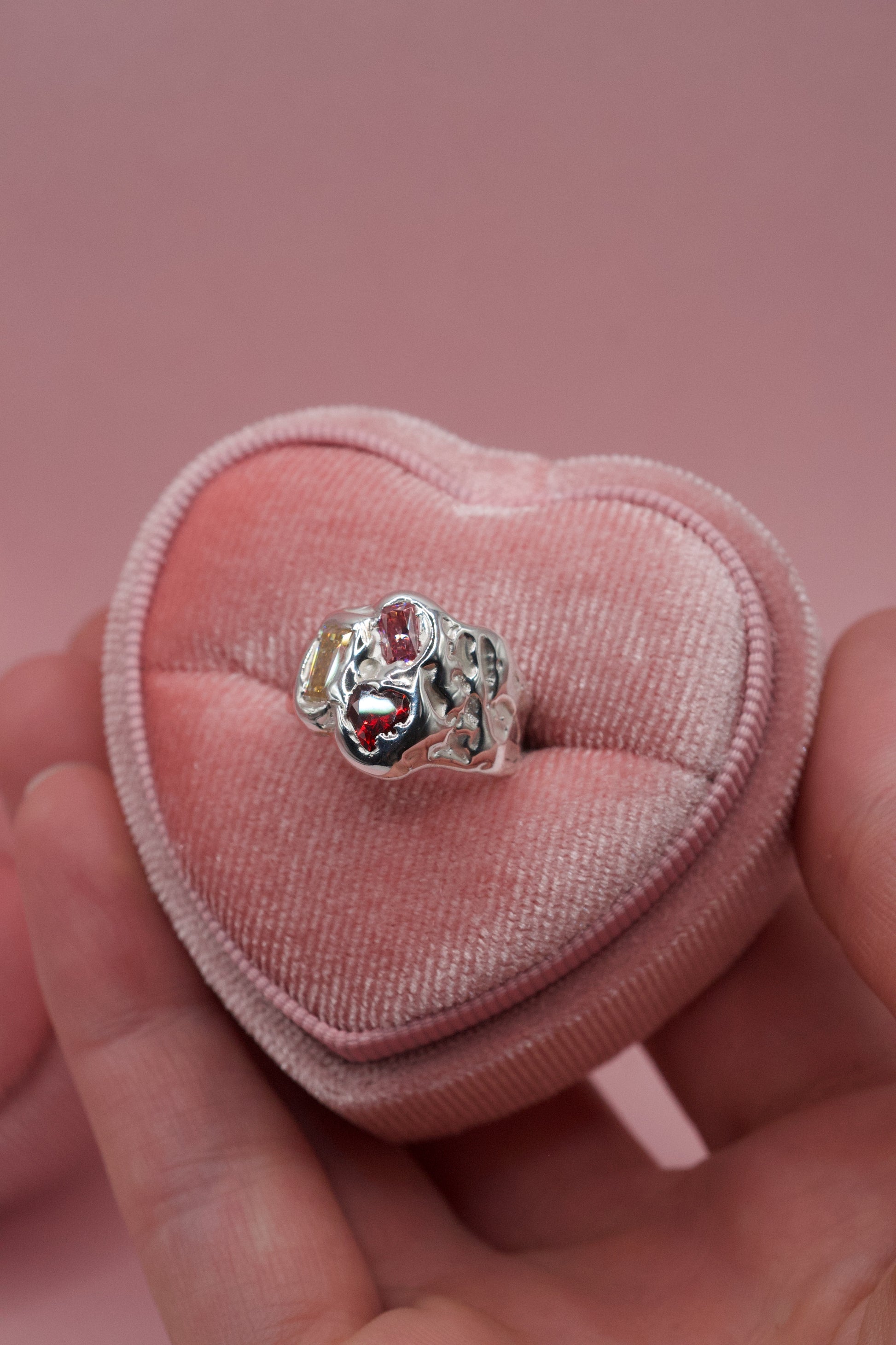 Handmade sterling silver ring with molten textures and multiple gemstones in a cluster organic design.