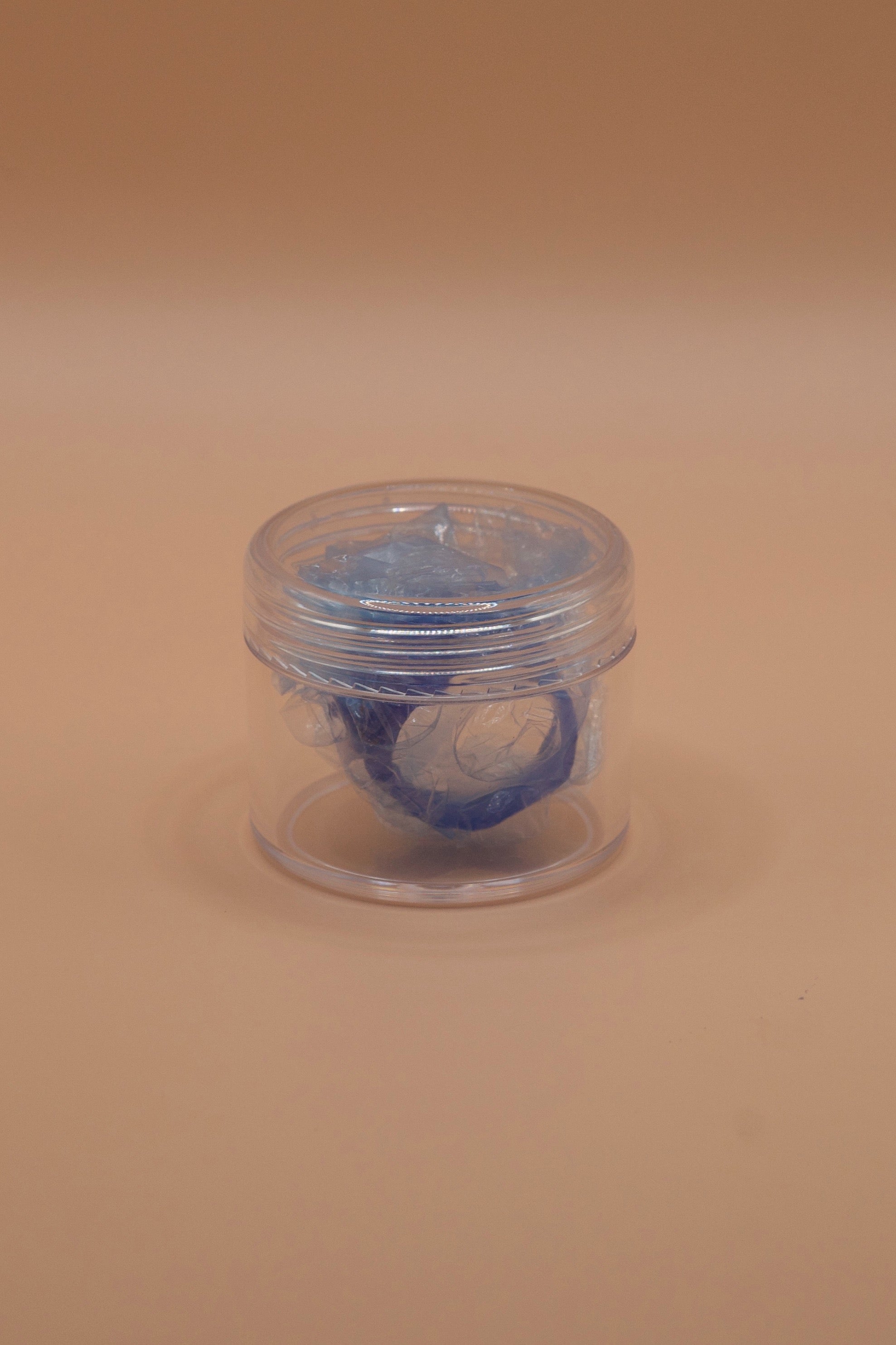 Clear plastic jar containing a wrapped wax jewellery model, showing how to pack and secure designs before sending to a casting house