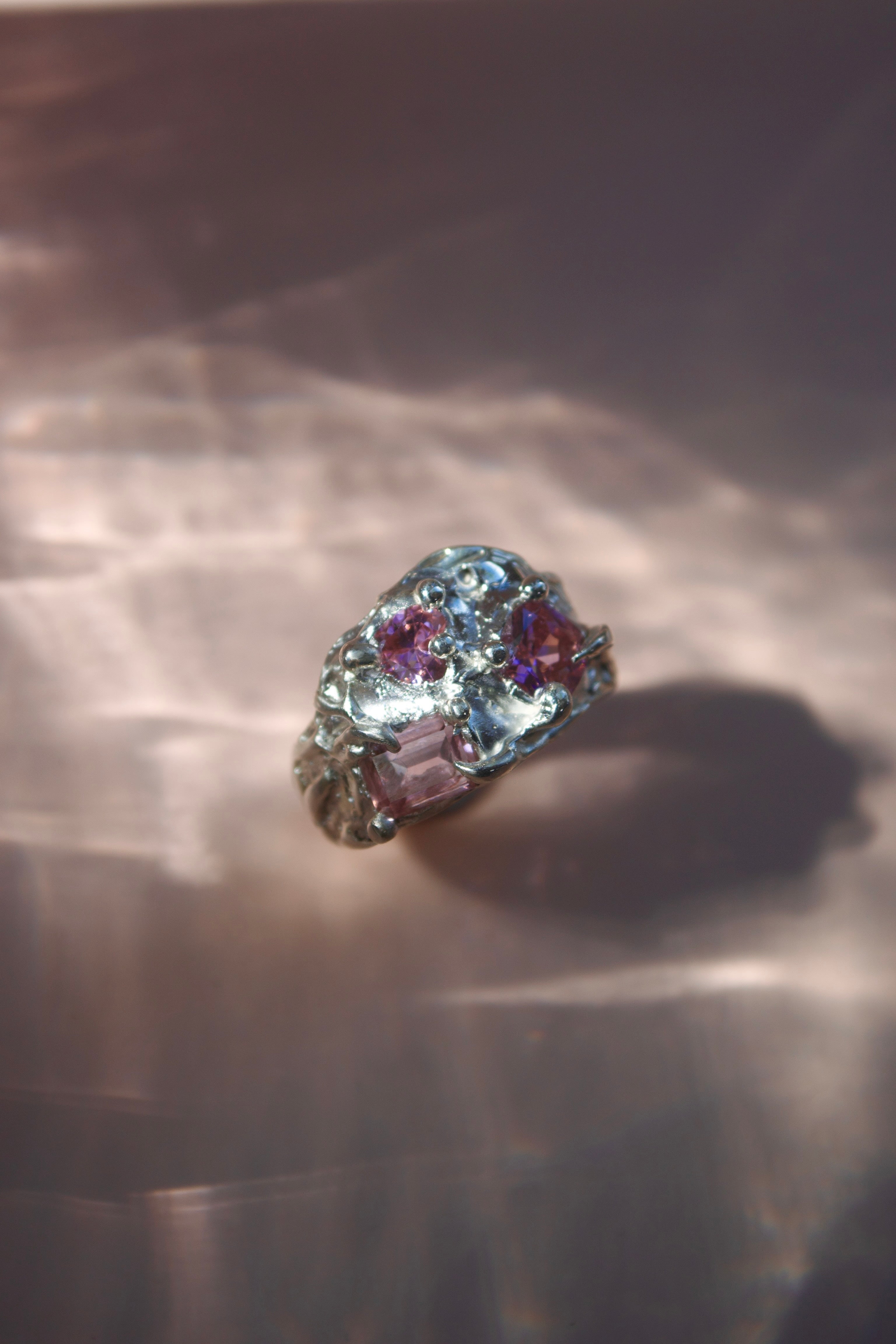 Stunning molten silver cluster ring with curves and melting look. Three light pink crystals - heart, square and cushion shaped. Flowing metal, princess looking jewellery. Fairytale aesthetic.