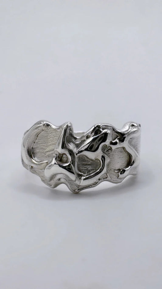 Personalised molten metal lost wax silver ring with a unique design that resembles melting metal or bubble writing. Hand carved from wax, cast in 100% recycled silver, it’s an ideal custom jewellery gift.