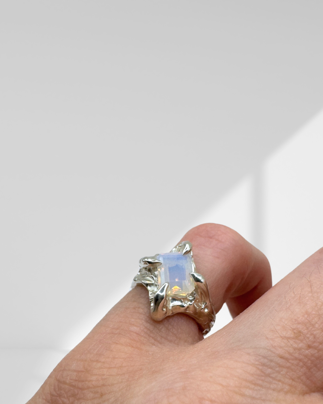 Unique claw setting sterling silver organic ring with milky opal lab grown crystal handmade with wax on hand