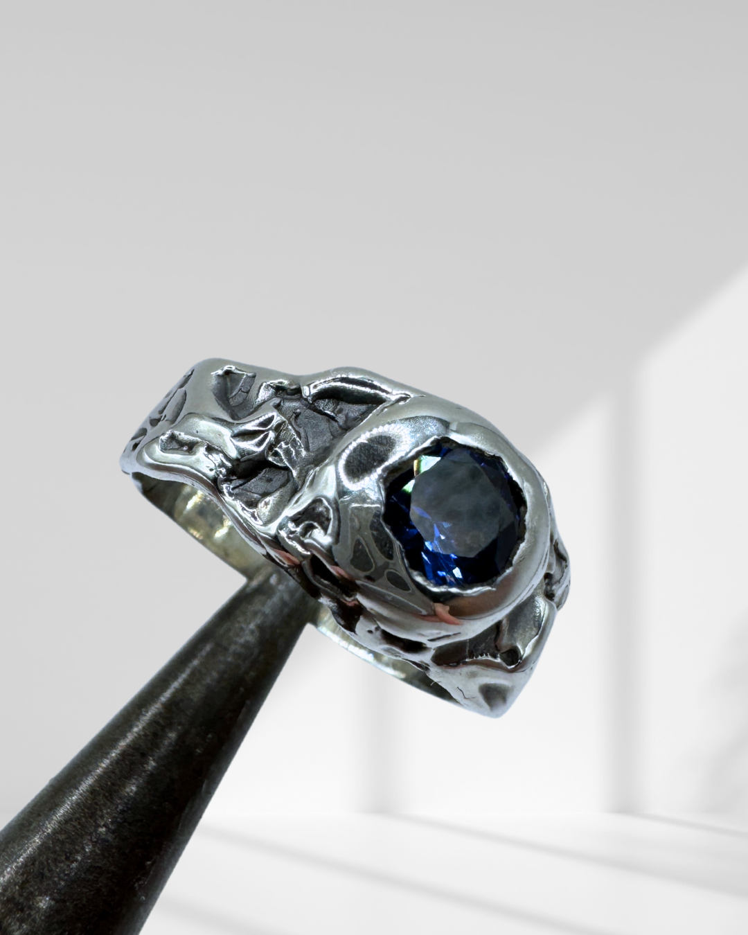 molten silver textured gothic ring with blue sapphire
