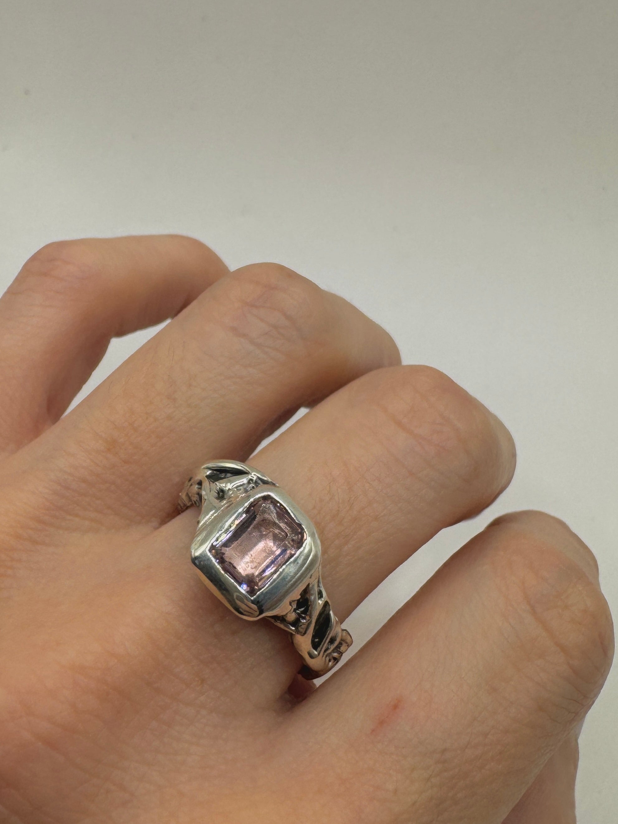 Organic design with vine texture, pink stone, and oxidized silver band.