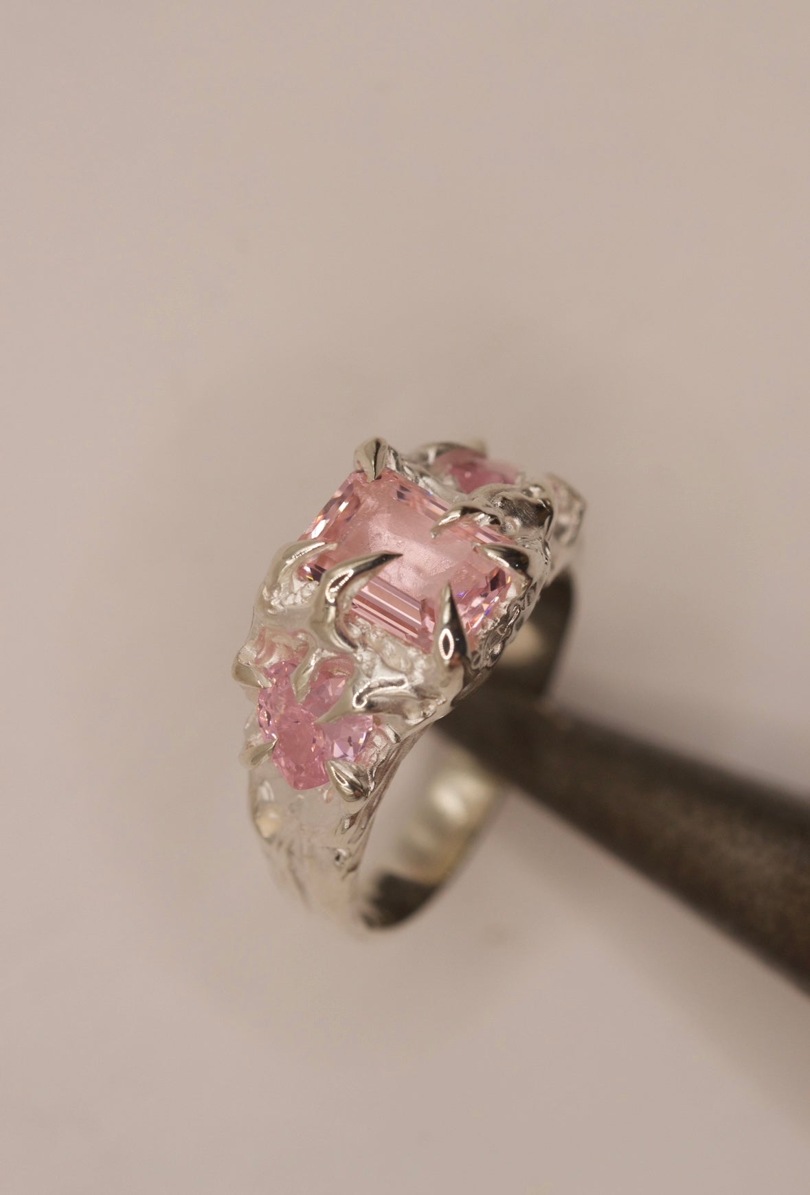 Hand-sculpted silver claw ring with pink emerald-cut and heart stones, molten organic design, alternative handmade jewellery for gothic and bold style