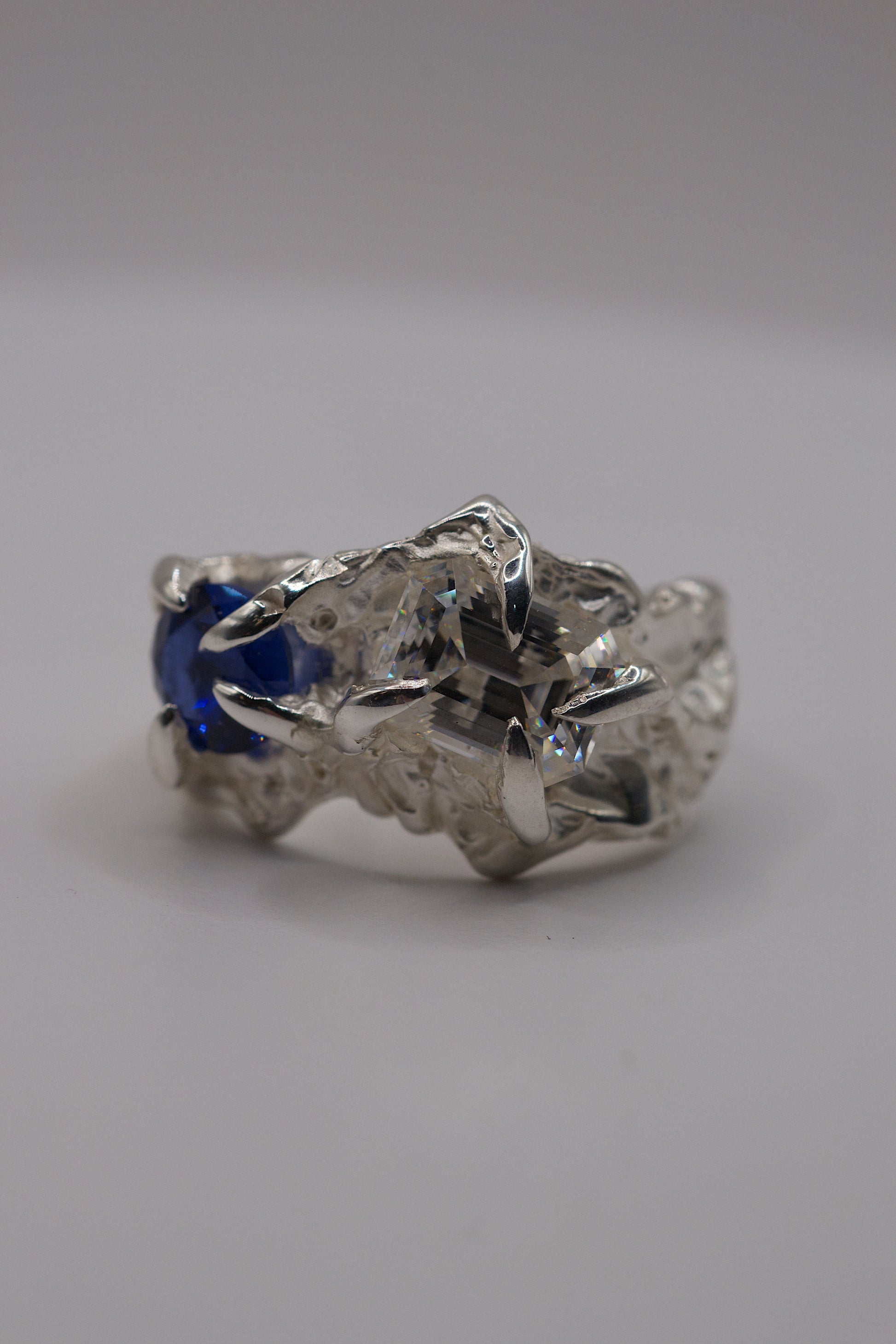 Organic handmade sterling silver lost wax ring with gothic claws and detailed textures.