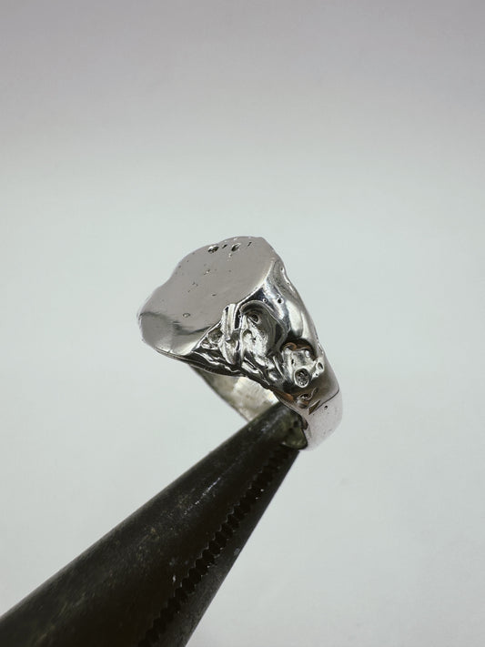 Stunning organic handmade signet ring with textured band and a flat smooth surface created using the lost wax method