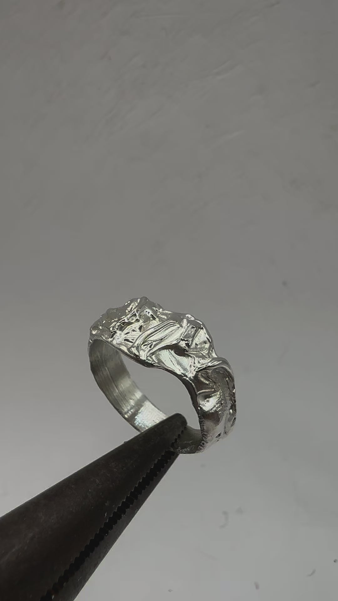 925 sterling silver band with an abstract, drippy design. The surface appears fluid and molten, with smooth contours interrupted by natural inclusions and irregular indentations, making each piece unique video.