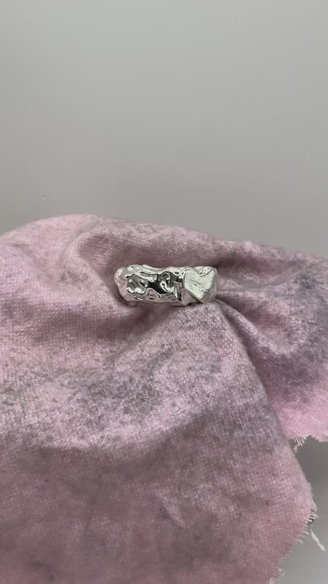 Organic handmade sterling silver ring with texture and fingerprint impression on surface