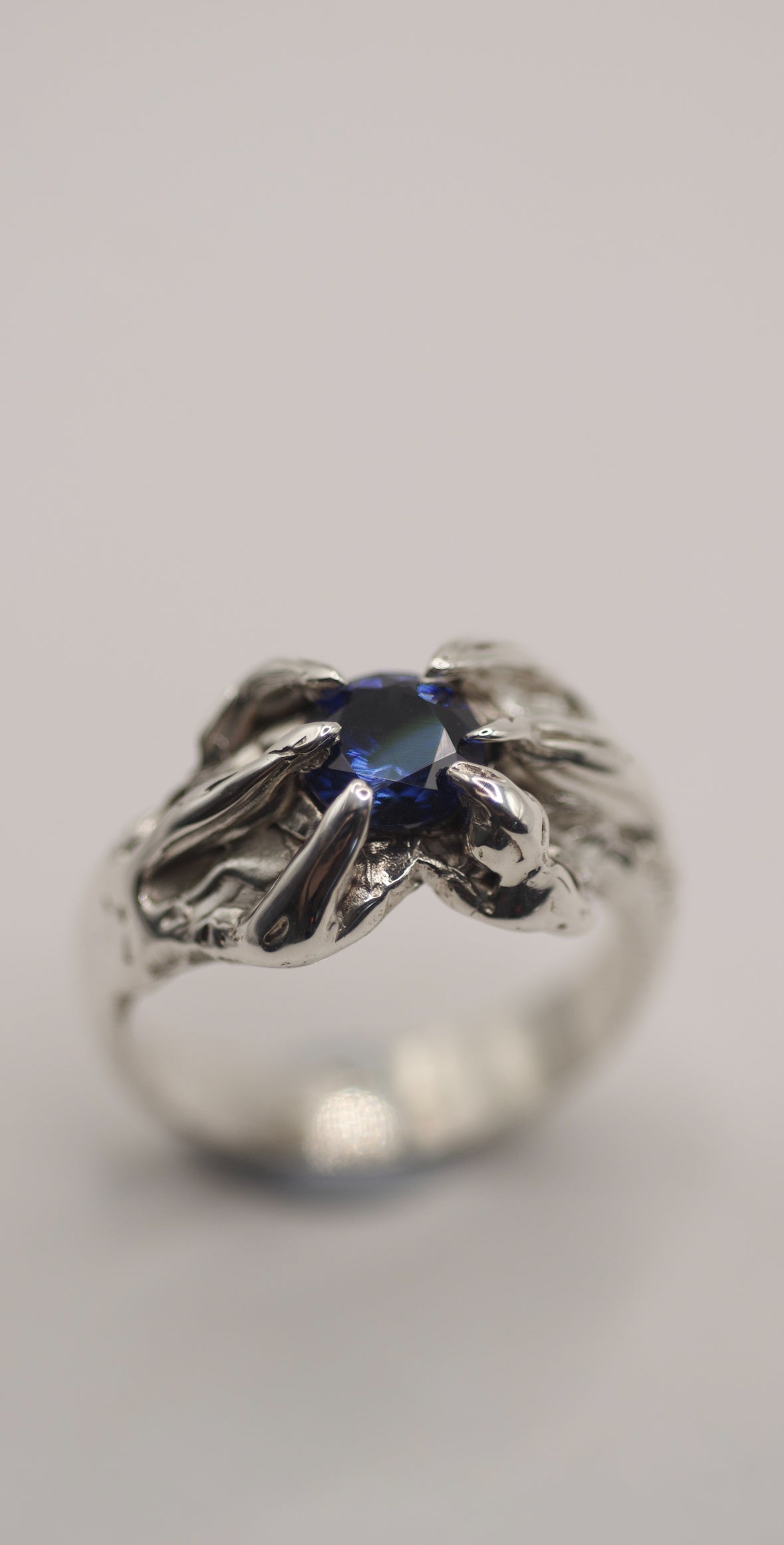 Handmade lost wax cast sterling silver ring with organic heavily darkened patina holding a vibrant blue natural sapphire, bold alternative ring made using the wax carving technique