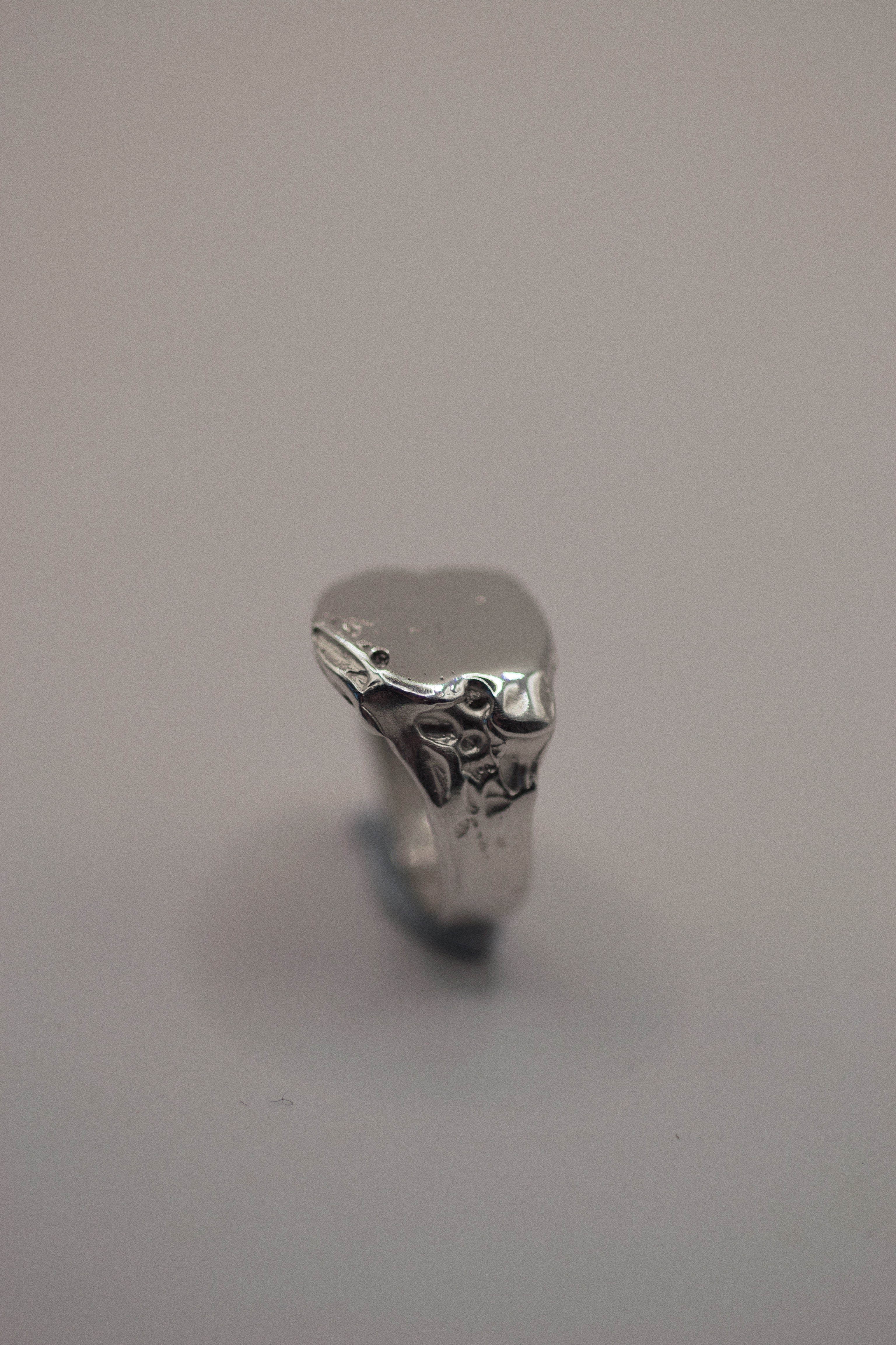 Flat view of the Raw Ring showing minimal textured recycled sterling silver signet form handmade using lost wax casting