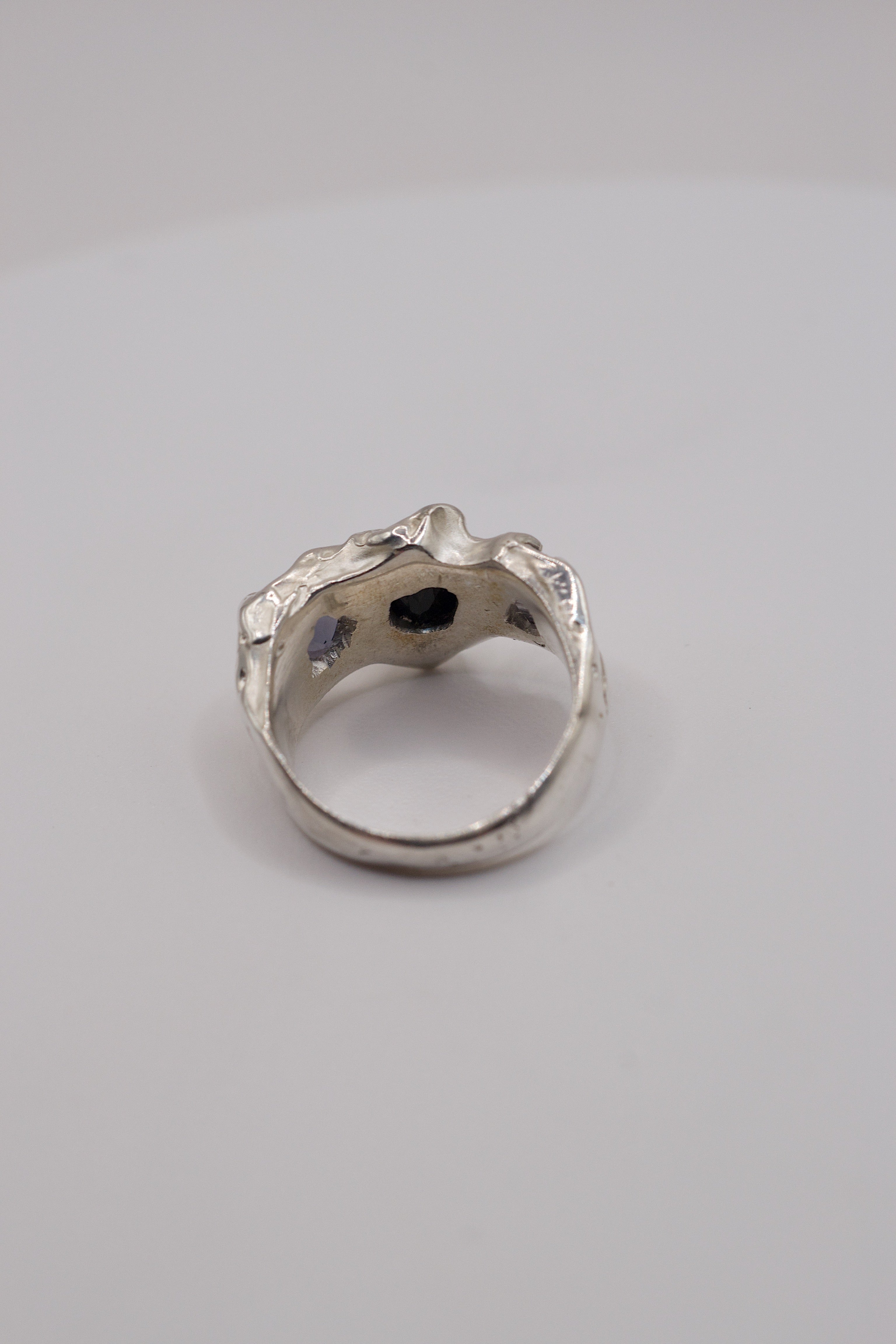 Rear view showing the holes behind the stones of the sterling silver black pear-cut gemstone ring.