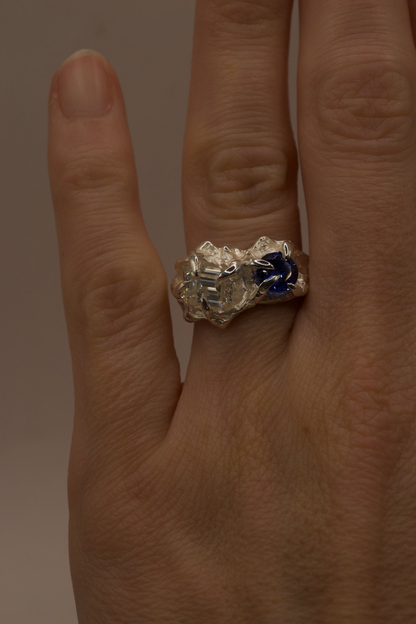 Front view image of sterling silver sapphire and moissanite ring on hand