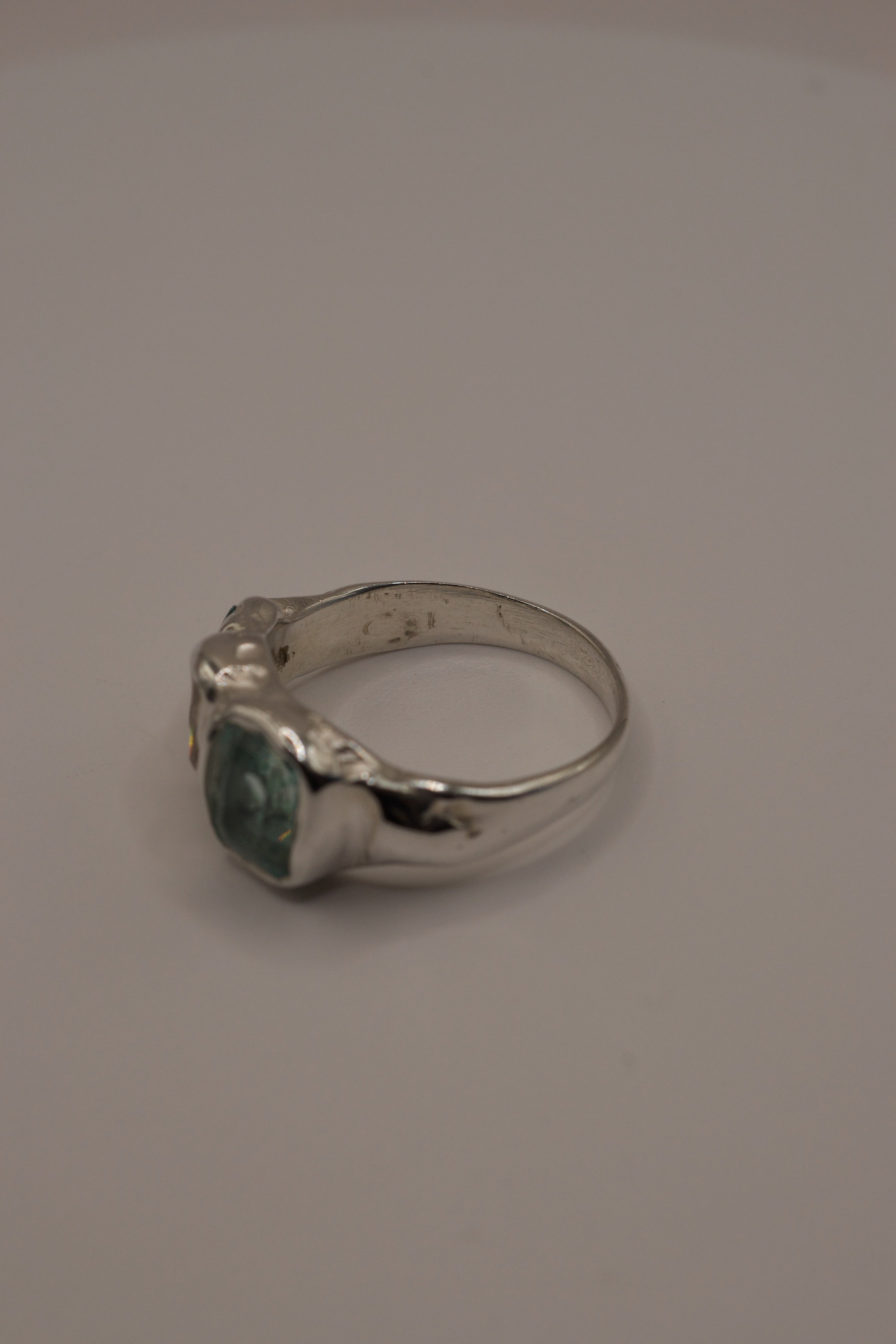 Flat view of the Seafoam Siren Ring showing organic recycled sterling silver band and aqua tourmaline with moissanite setting