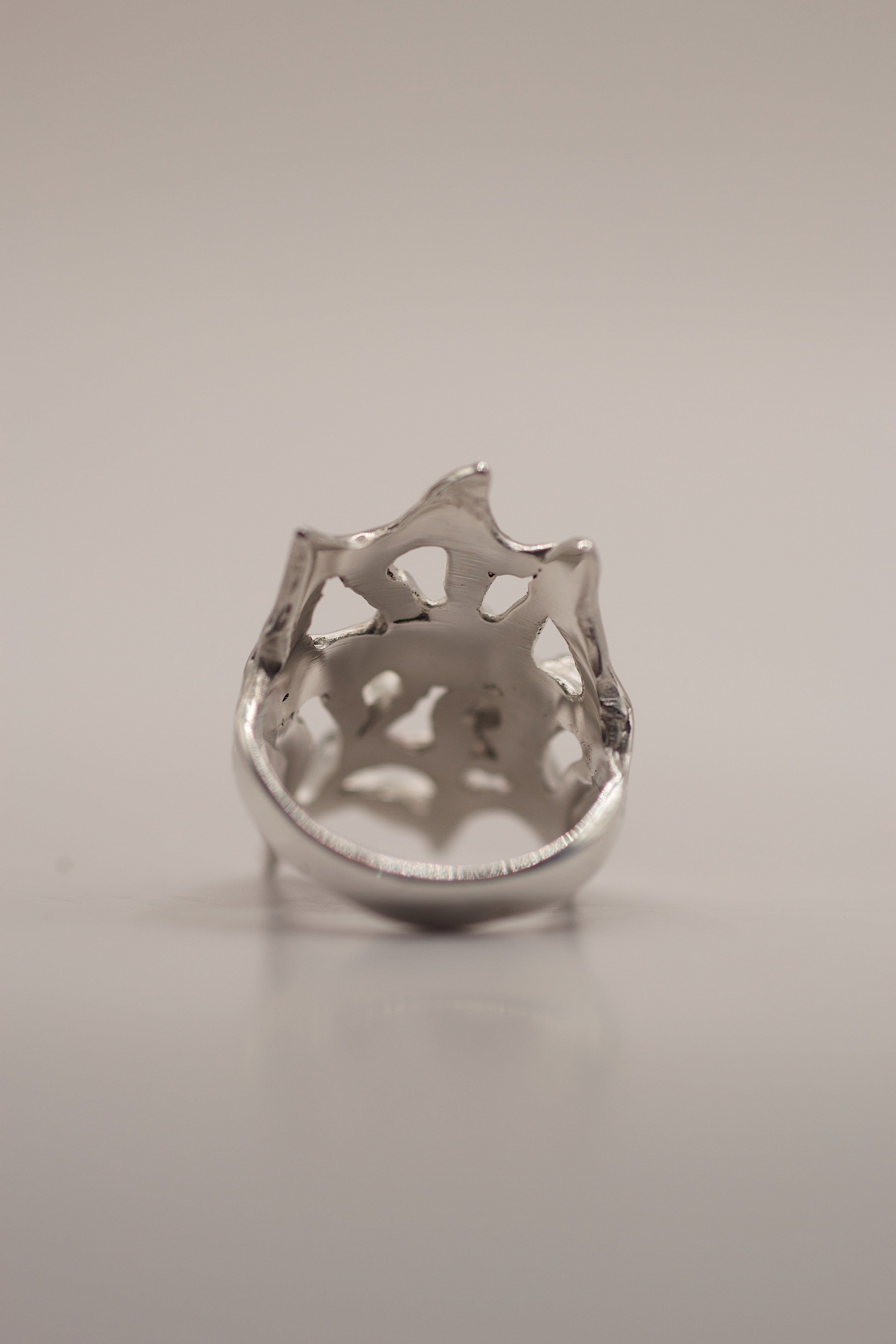 Flat view of the Silk Ring showing organic flowing sterling silver web structure and pink heart cubic zirconia handmade using lost wax casting