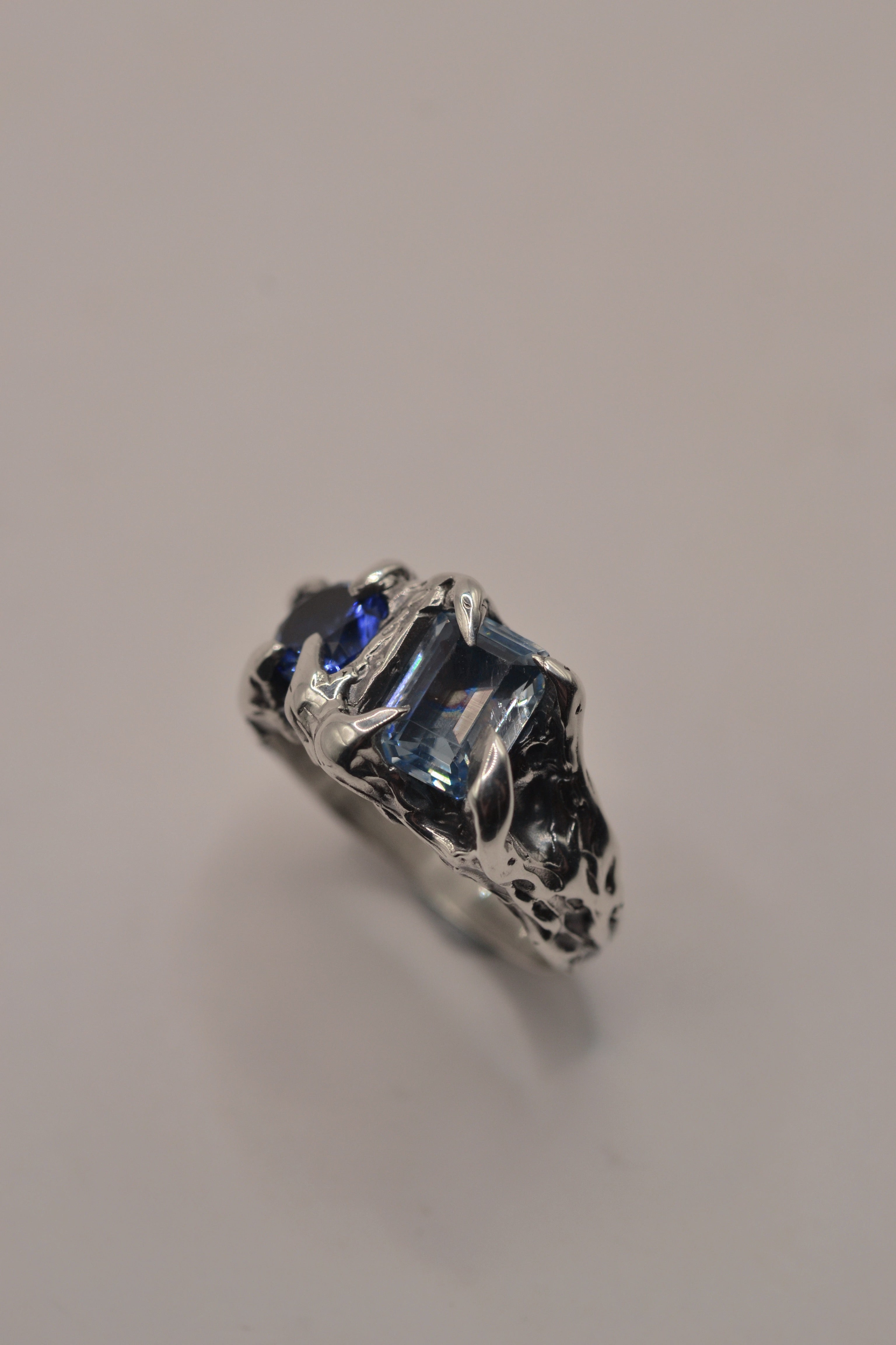 Sculptural darkened alternative jewellery Something Blue Ring lost wax cast in sterling silver with blue sapphire and topaz