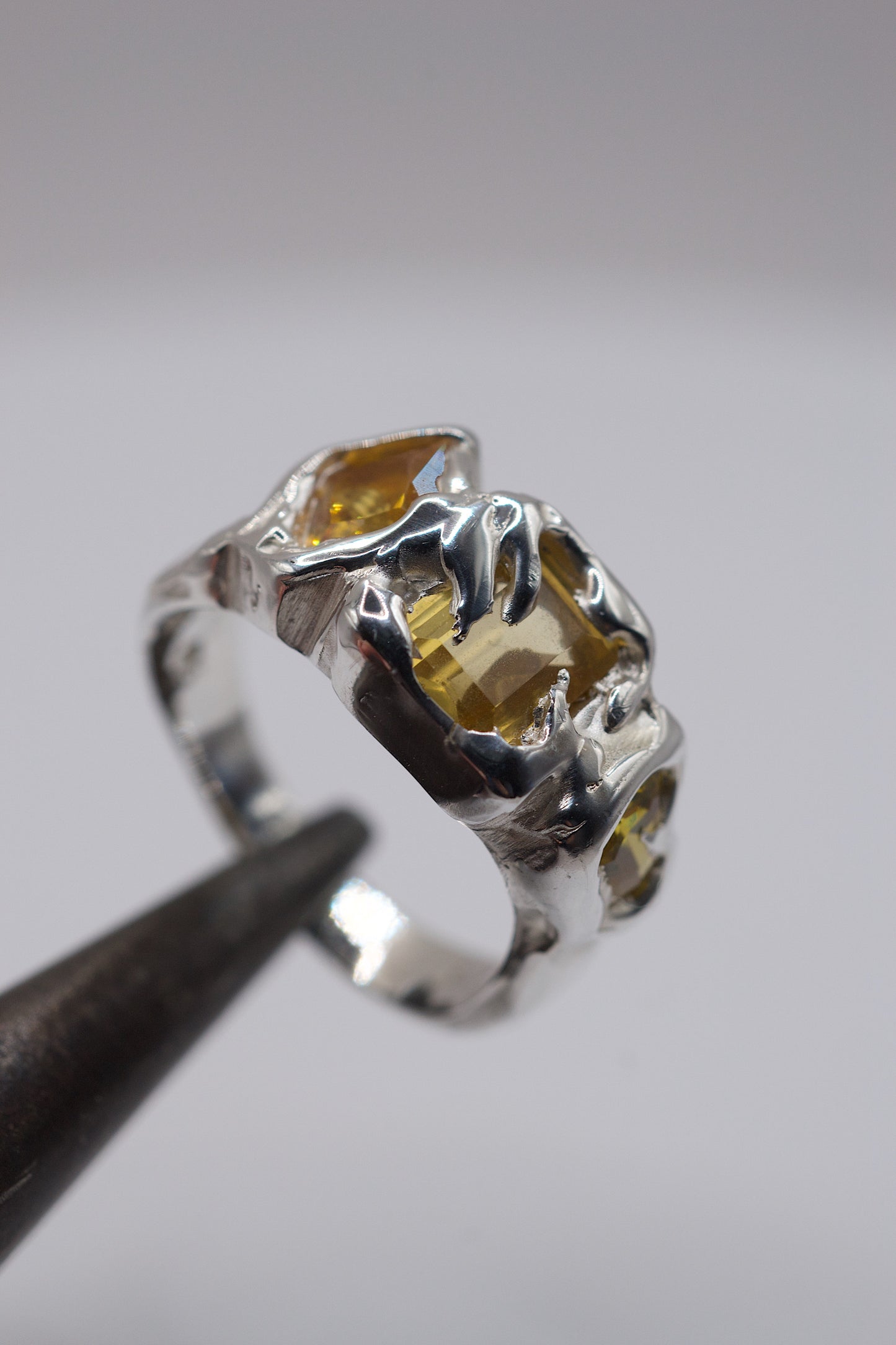Molten silver ring with yellow fancy-cut gemstones. 