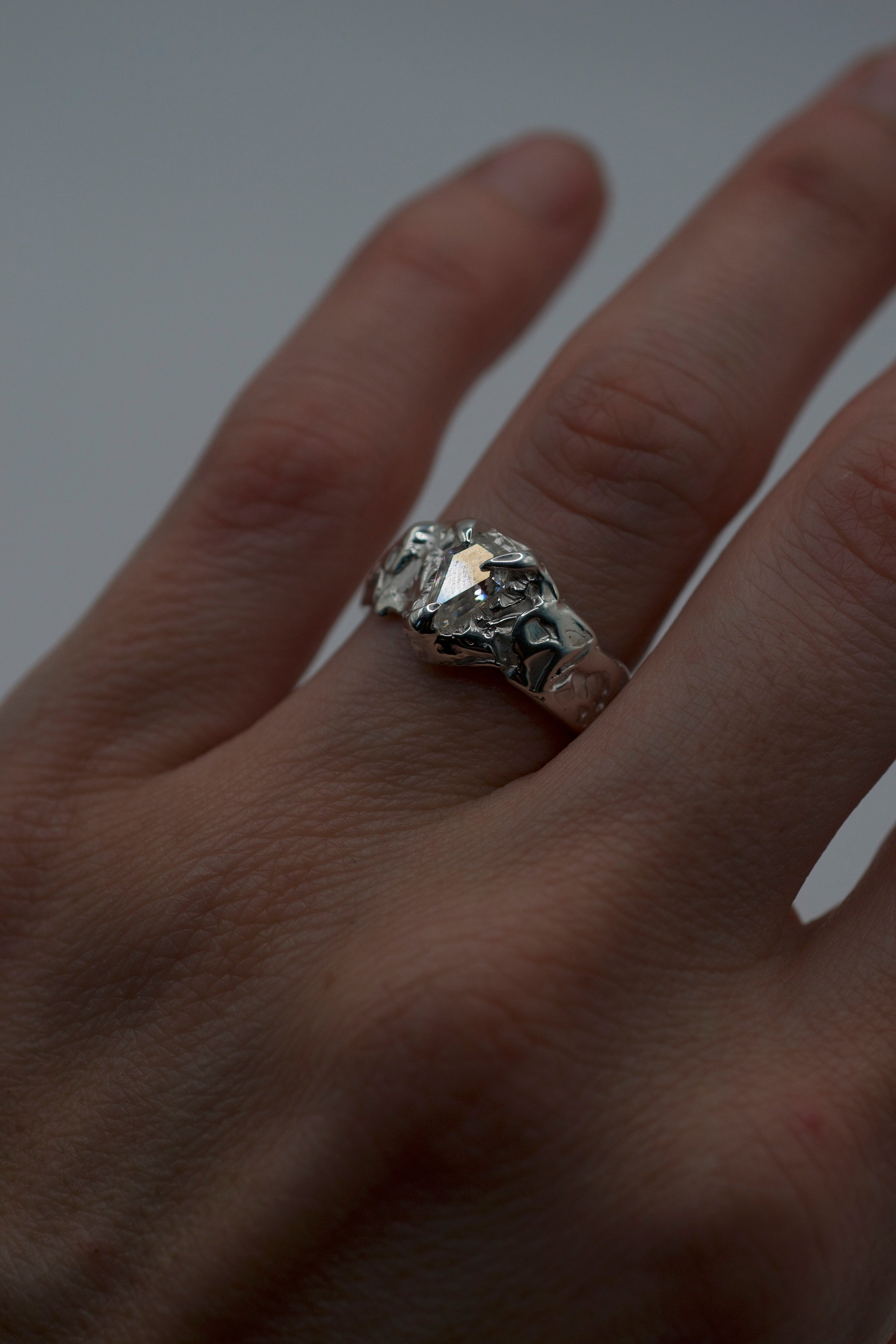 Lost wax cast silver Til Death Ring worn on hand non traditional alternative engagement ring with kite cut moissanite and organic textured band